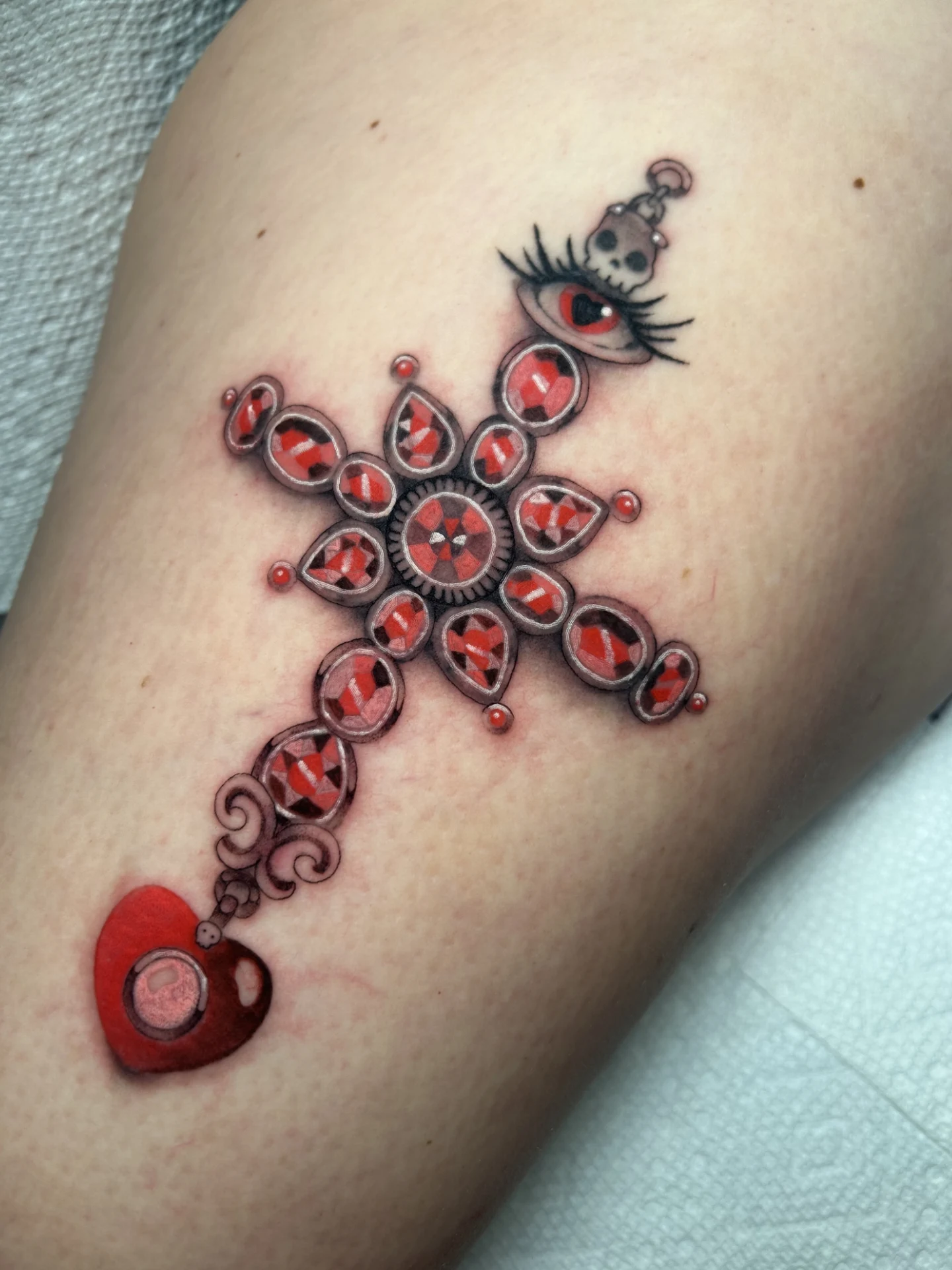 Cross with eye geometric tattoo on the forearm by Chloe Marie