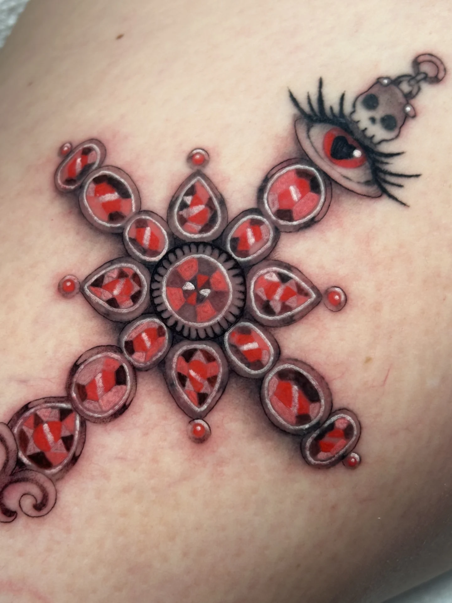 Jeweled cross geometric tattoo on the thigh by Chloe Marie