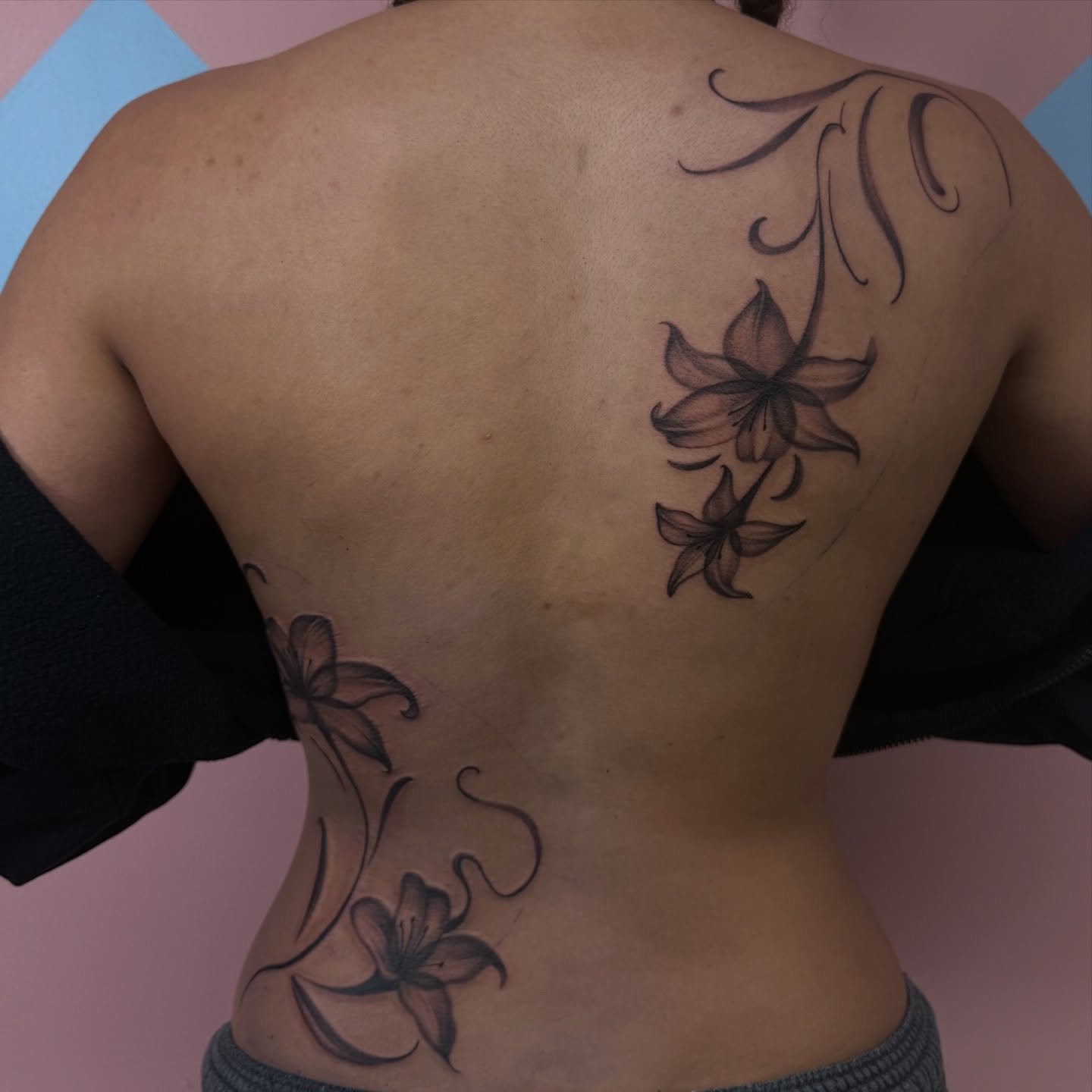 Lilies black and grey tattoo on the back by Eva, Matawan, New Jersey
