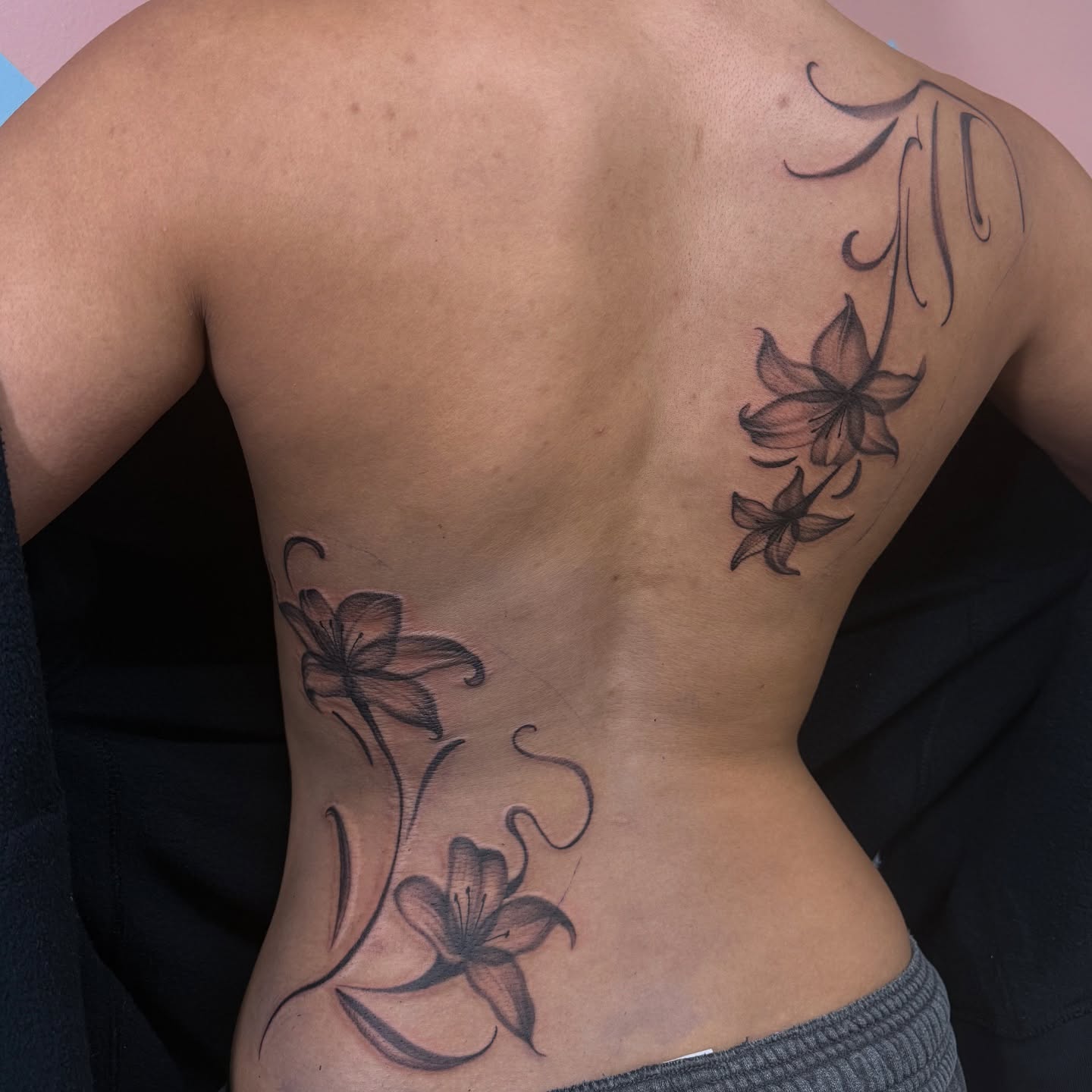 Lilies black and grey tattoo on the back by Eva, Matawan, New Jersey