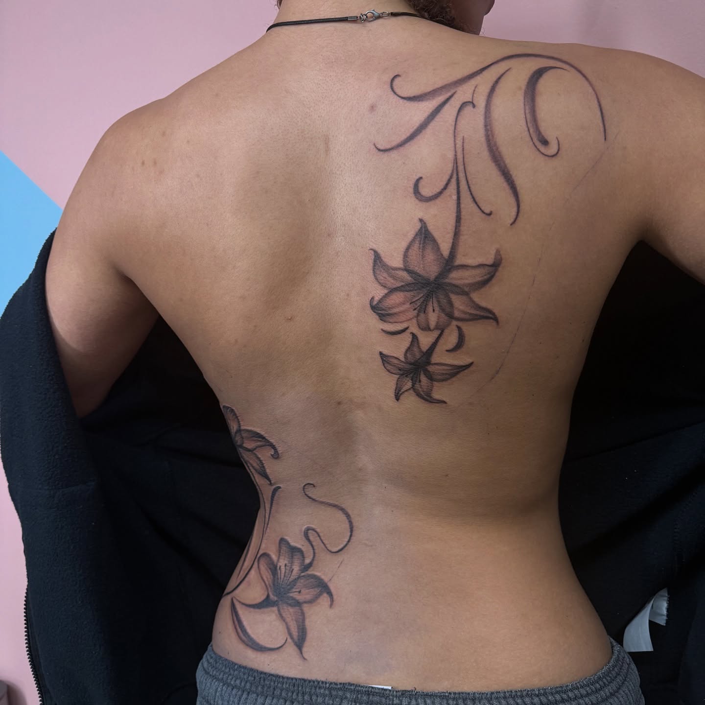 Lily flowers black and grey tattoo on the back by Eva, Matawan, New Jersey