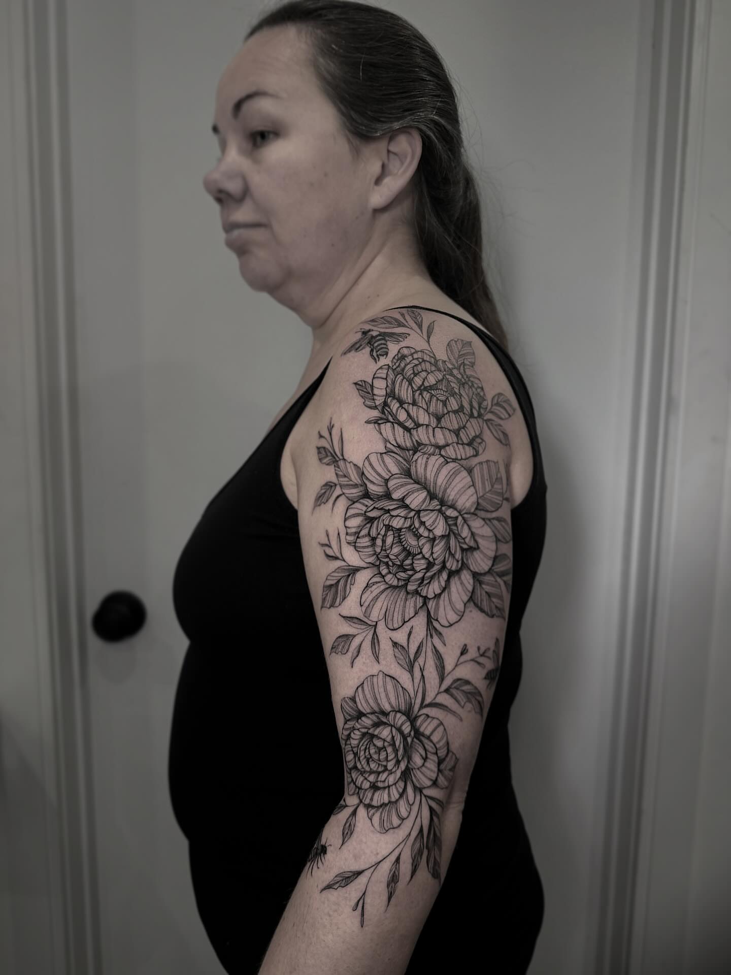 Floral bouquet black and grey tattoo on the upper arm by Tattoo Ottawa