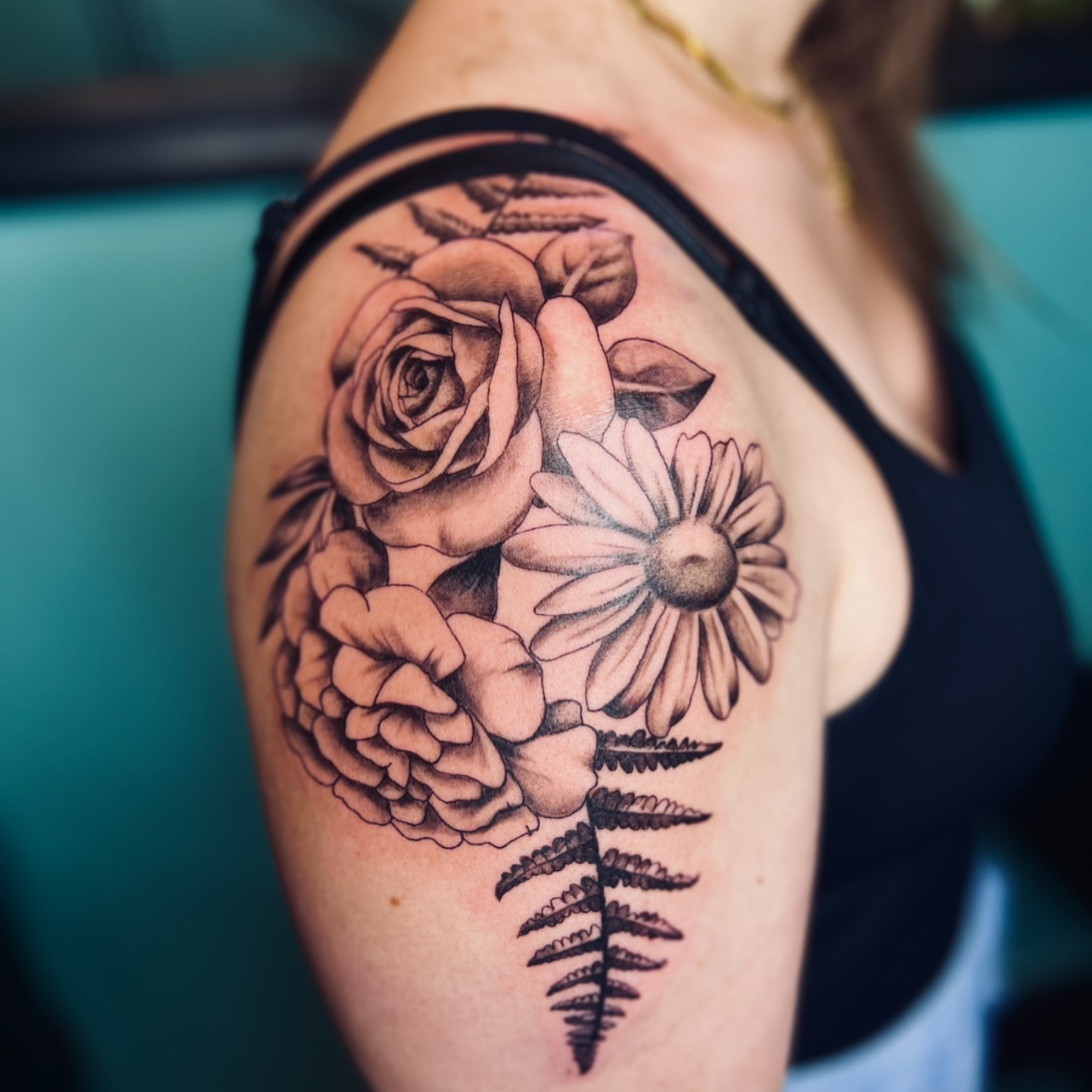 Floral arrangement realism tattoo on the shoulder by Sydney Rose