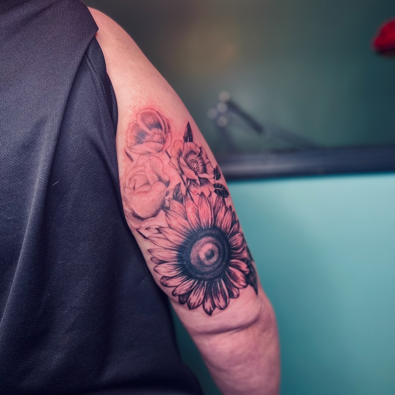 Sunflower and roses black and grey tattoo on the forearm by Sydney Rose