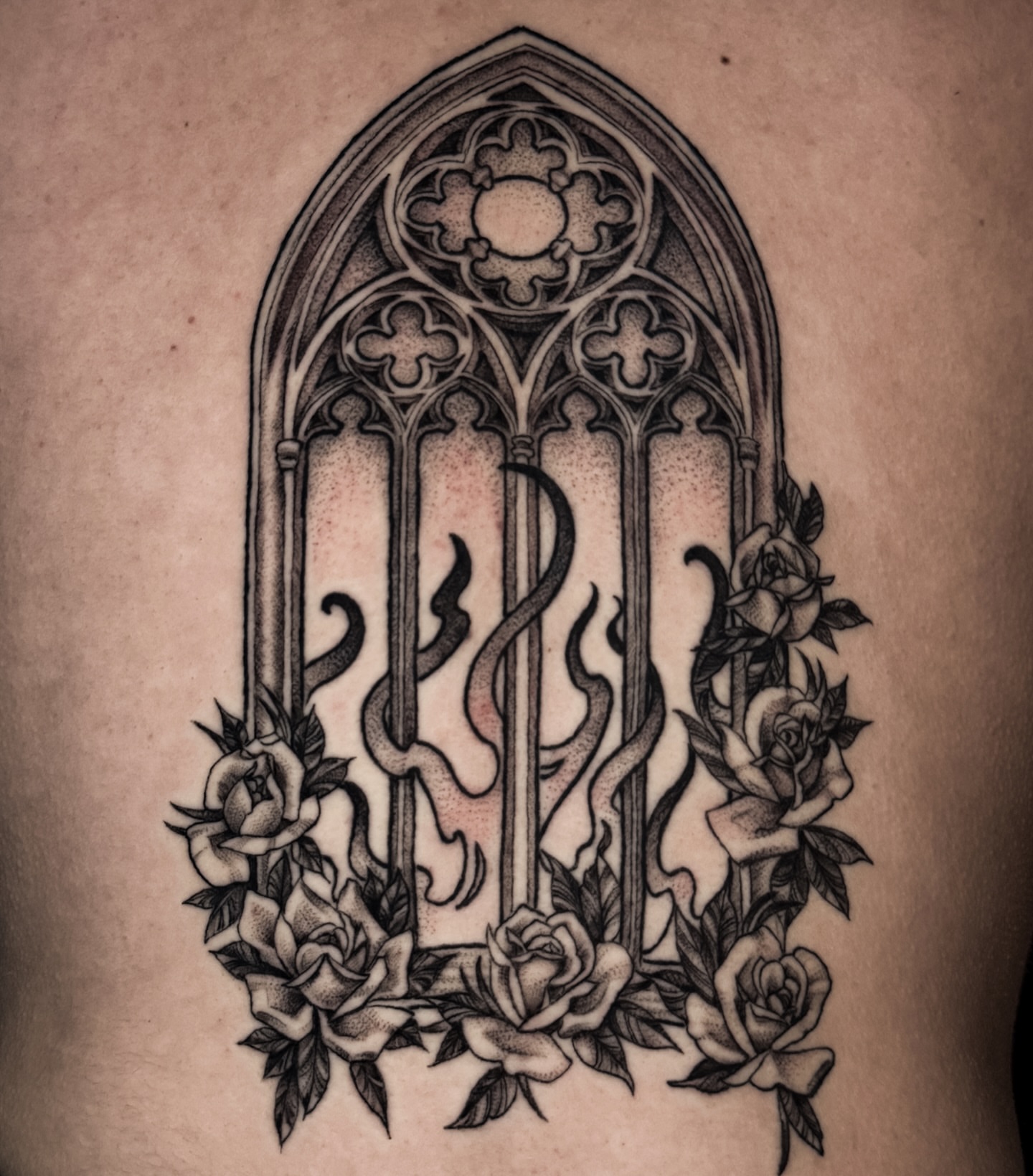 Gothic window with roses ornamental tattoo on the thigh by Cristen Aro