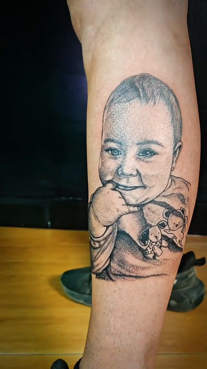 Baby portrait realism tattoo on the forearm by Juanma Martin