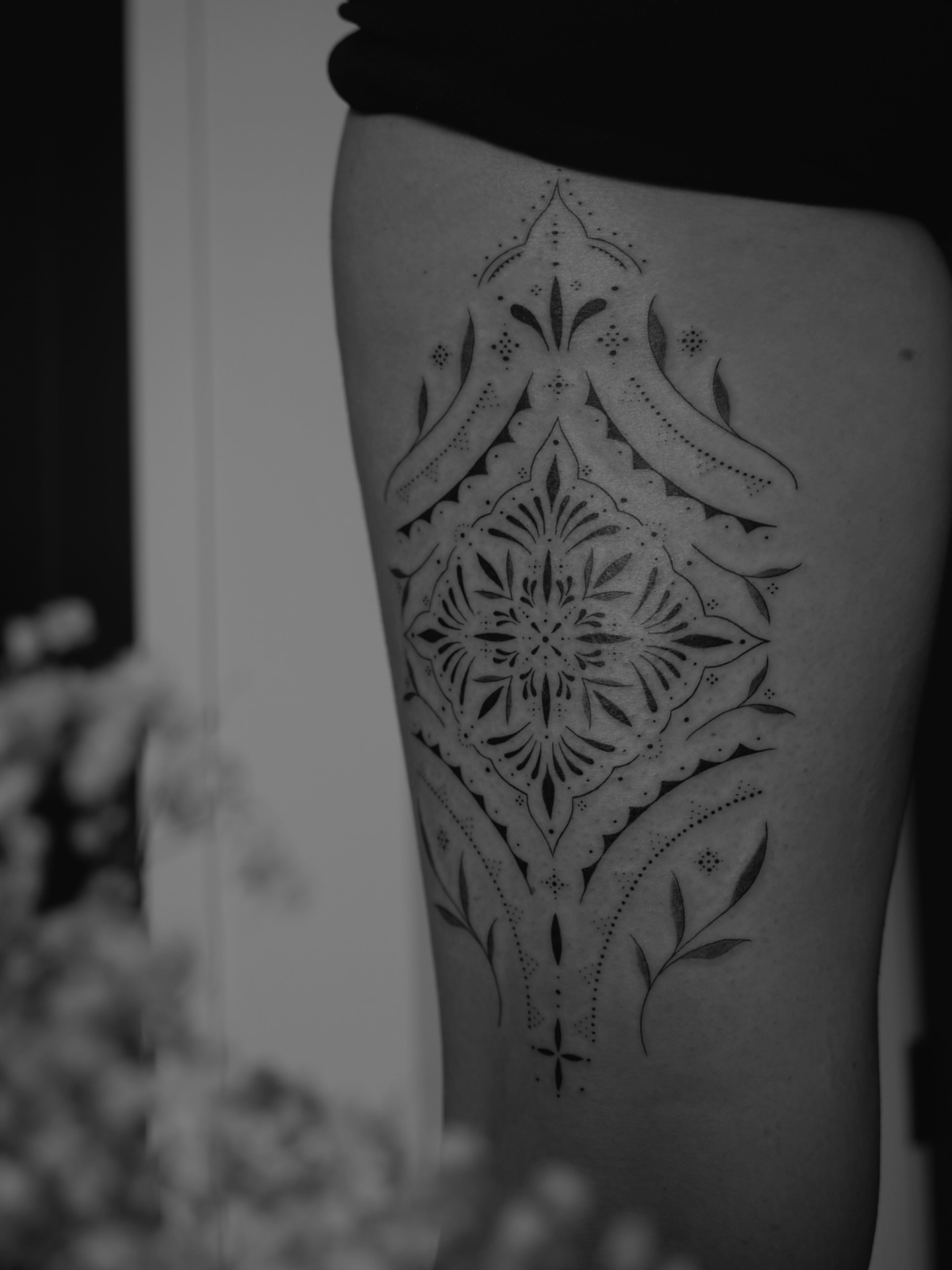 Geometric mandala dotwork tattoo on the thigh by Haley Sayers