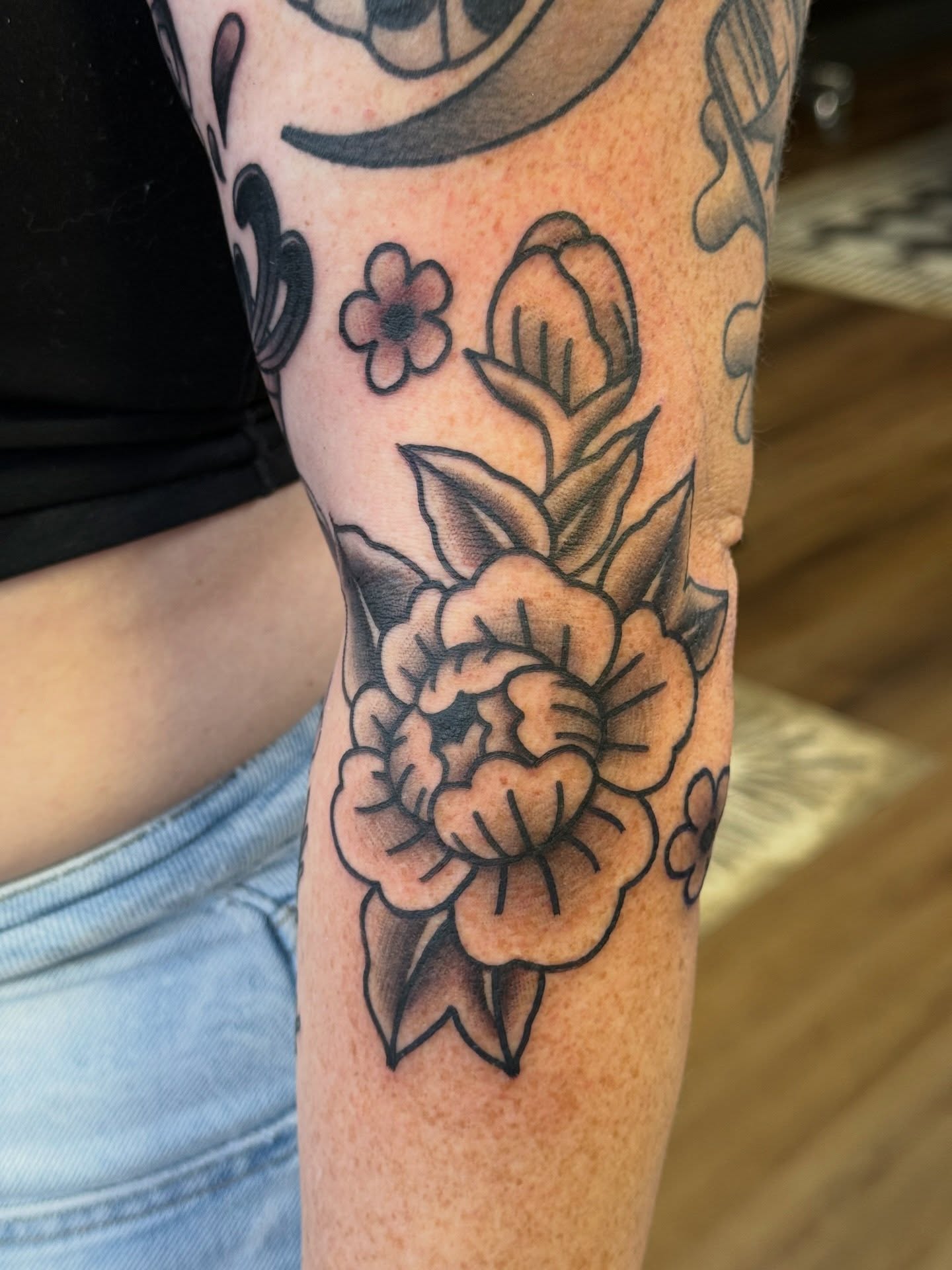 Peony flowers American traditional tattoo on the forearm by Kelsey Louis, Iowa City, Iowa