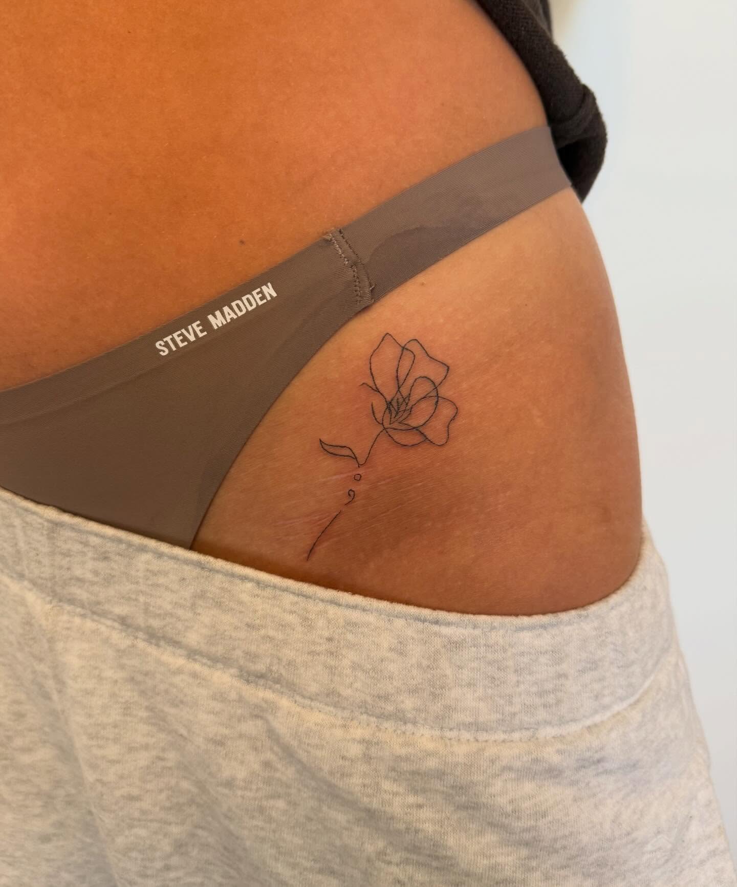 Flower fine line tattoo on the thigh by Lexie Decker, Canton, Ohio