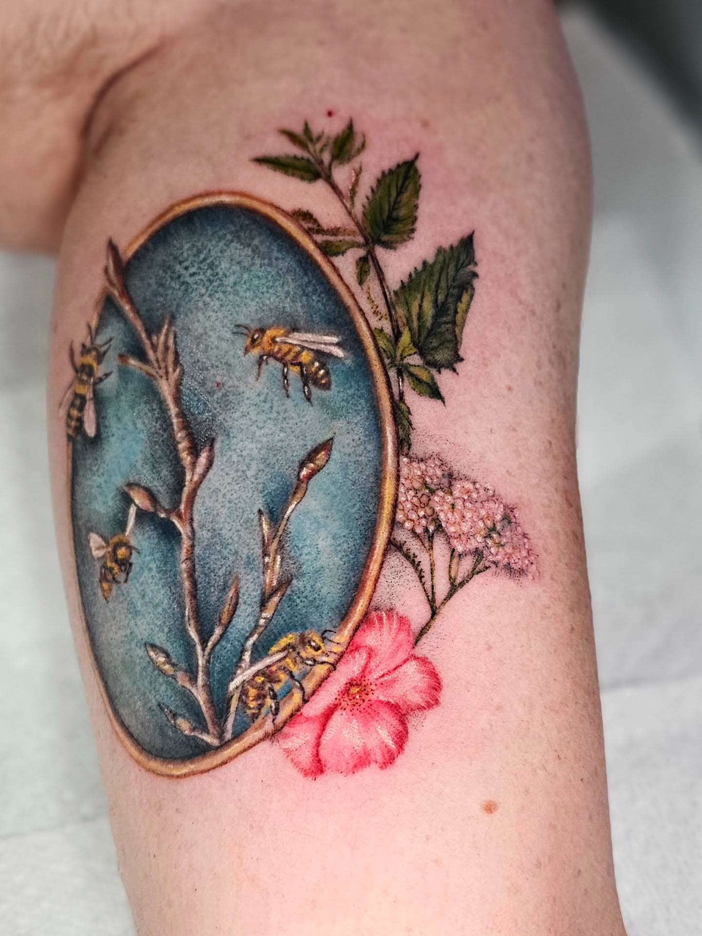 Bees and flowers realism tattoo on the thigh by Madelynne