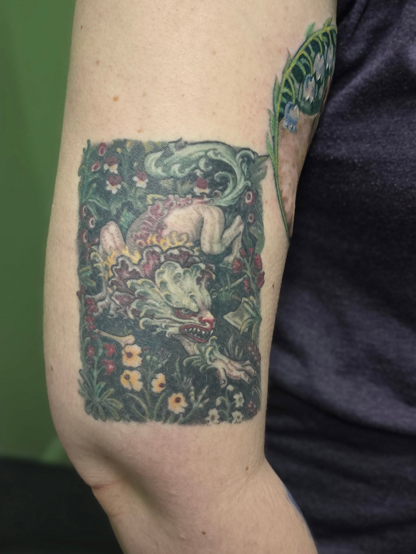 Mythical creature in garden illustrative tattoo on the forearm by Lizz Zonno, Naperville, Illinois