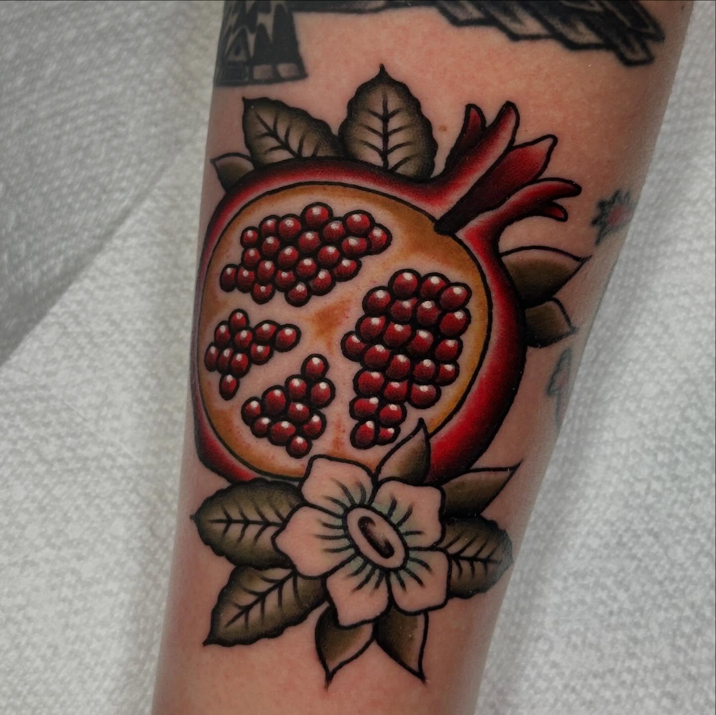 Pomegranate American traditional tattoo on the forearm by Kyle Logan Frary