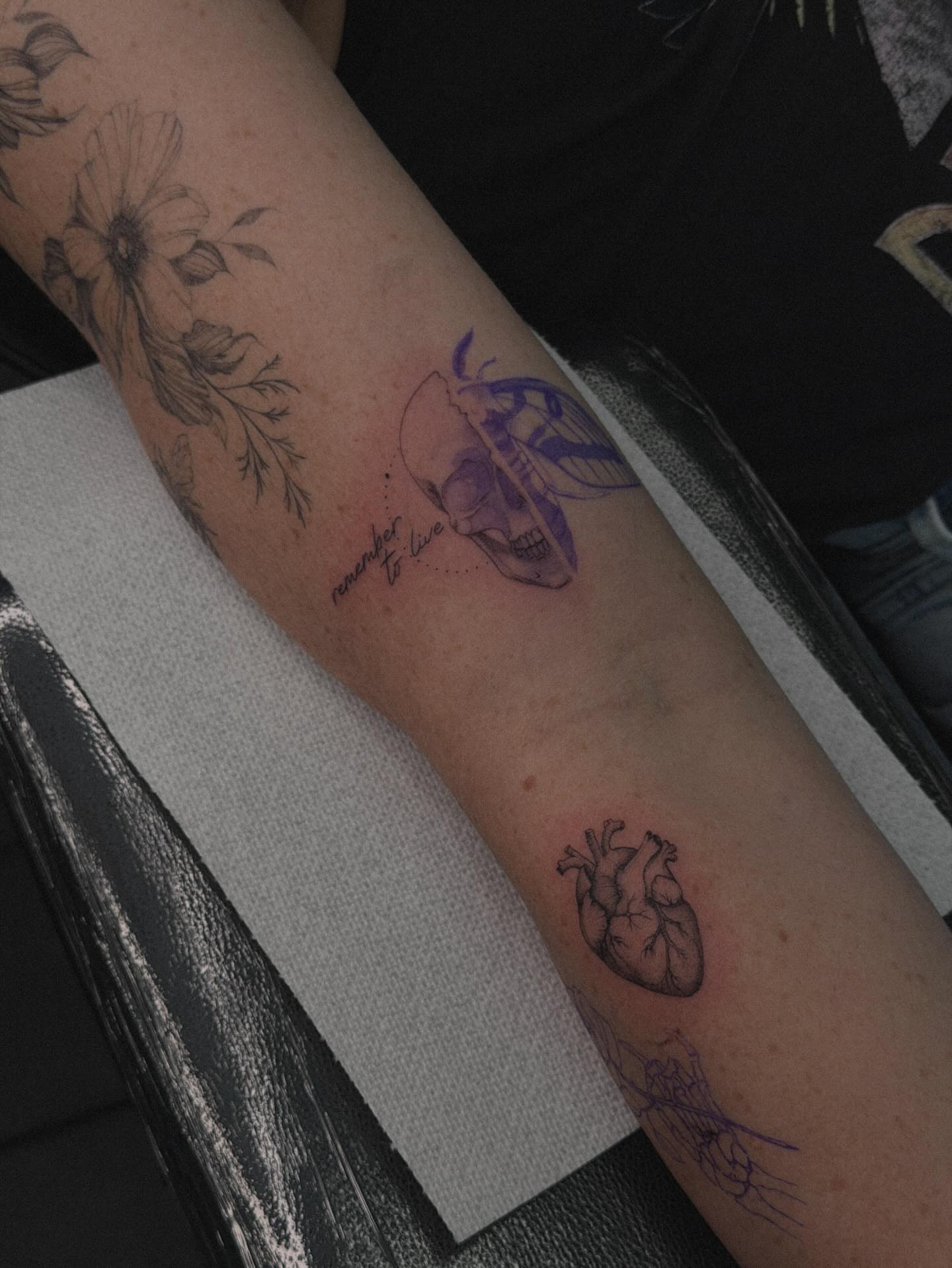 Skull and heart black and grey tattoo on the forearm by Hannah Matthews