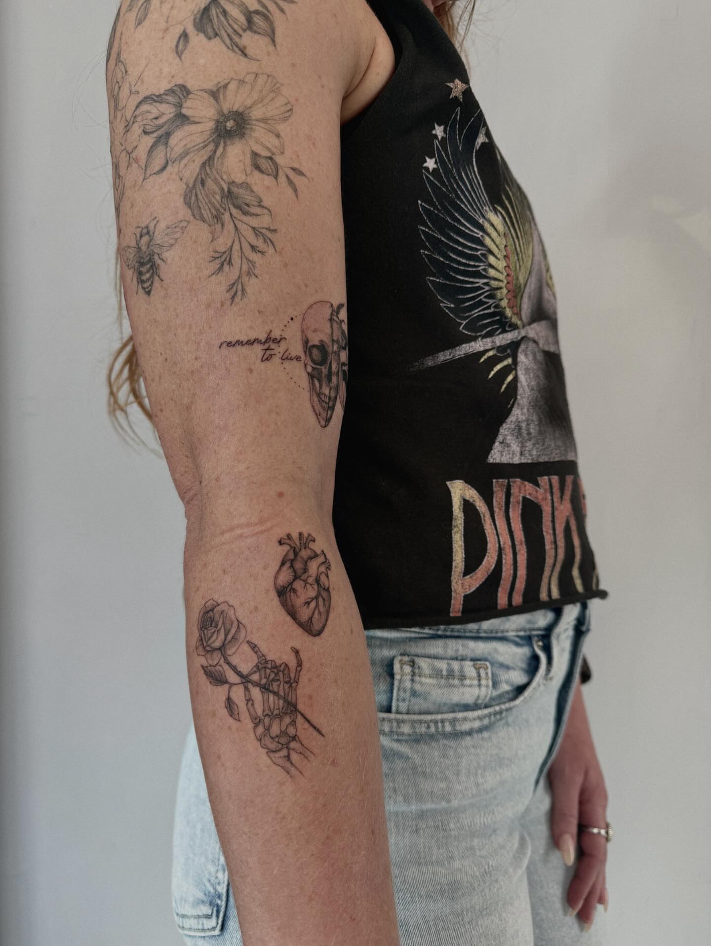 Heart and hand black and grey tattoo on the forearm by Hannah Matthews