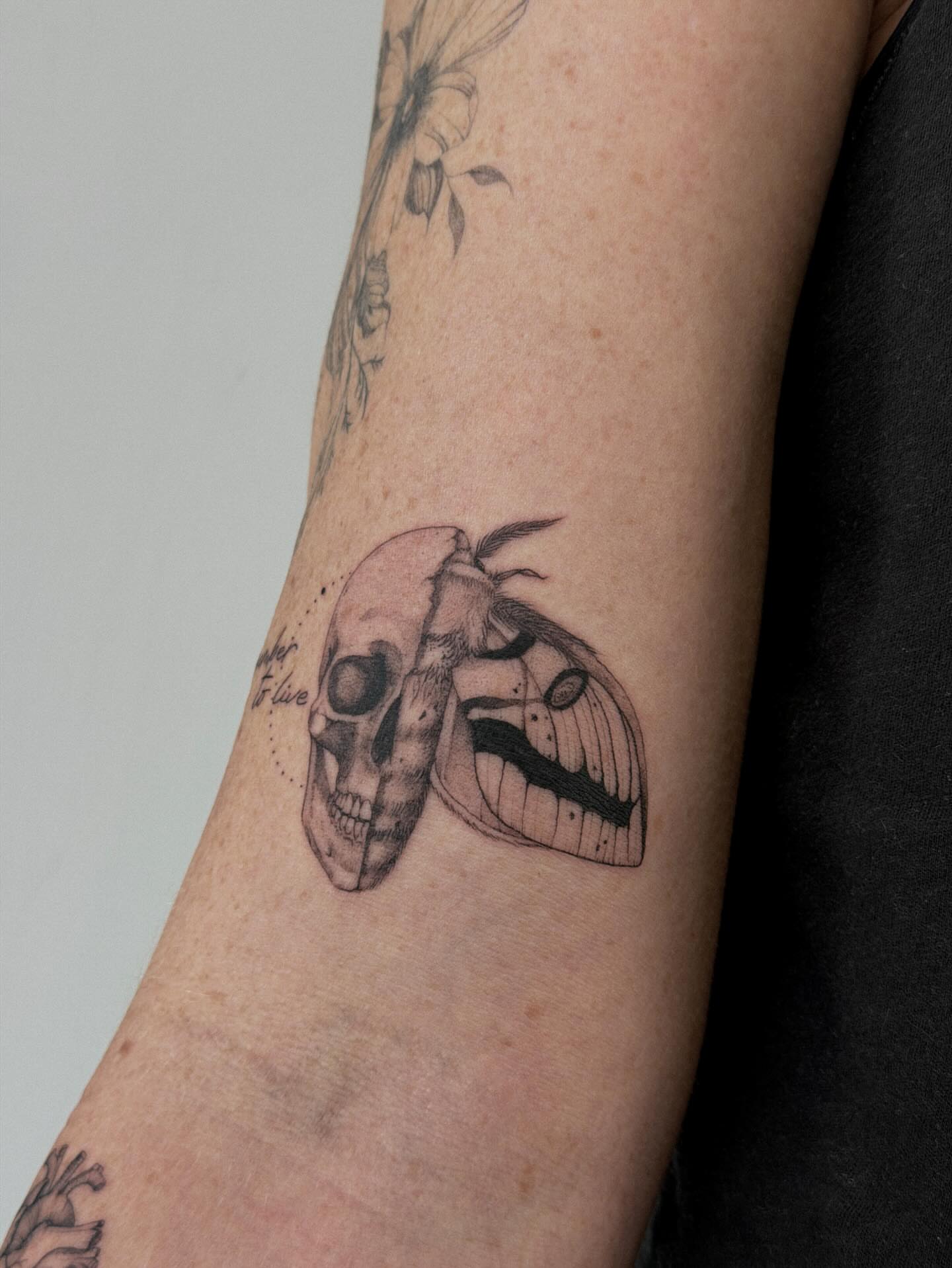 Skull and moth realism tattoo on the forearm by Hannah Matthews