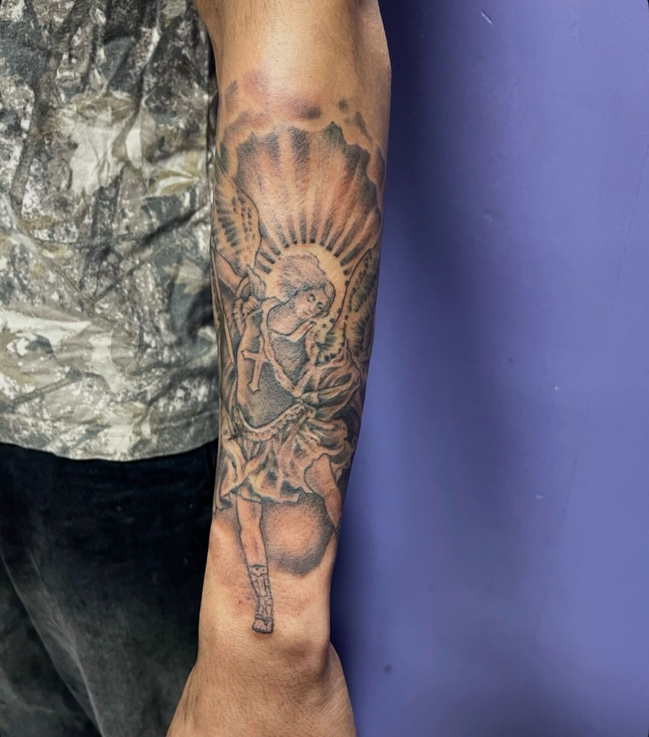 Angel with cross American traditional tattoo on the forearm by Mark Calloway