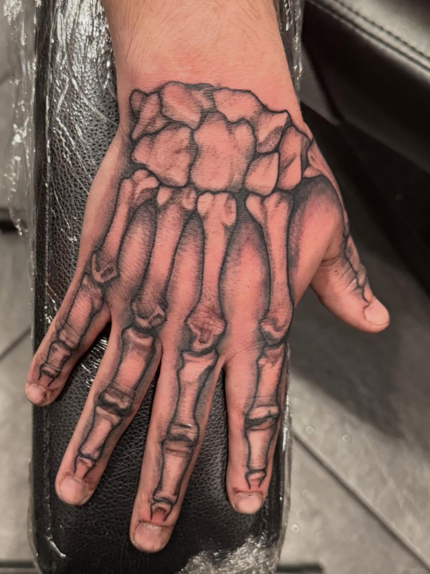 Skeleton hand realism tattoo on the hand by Courtney