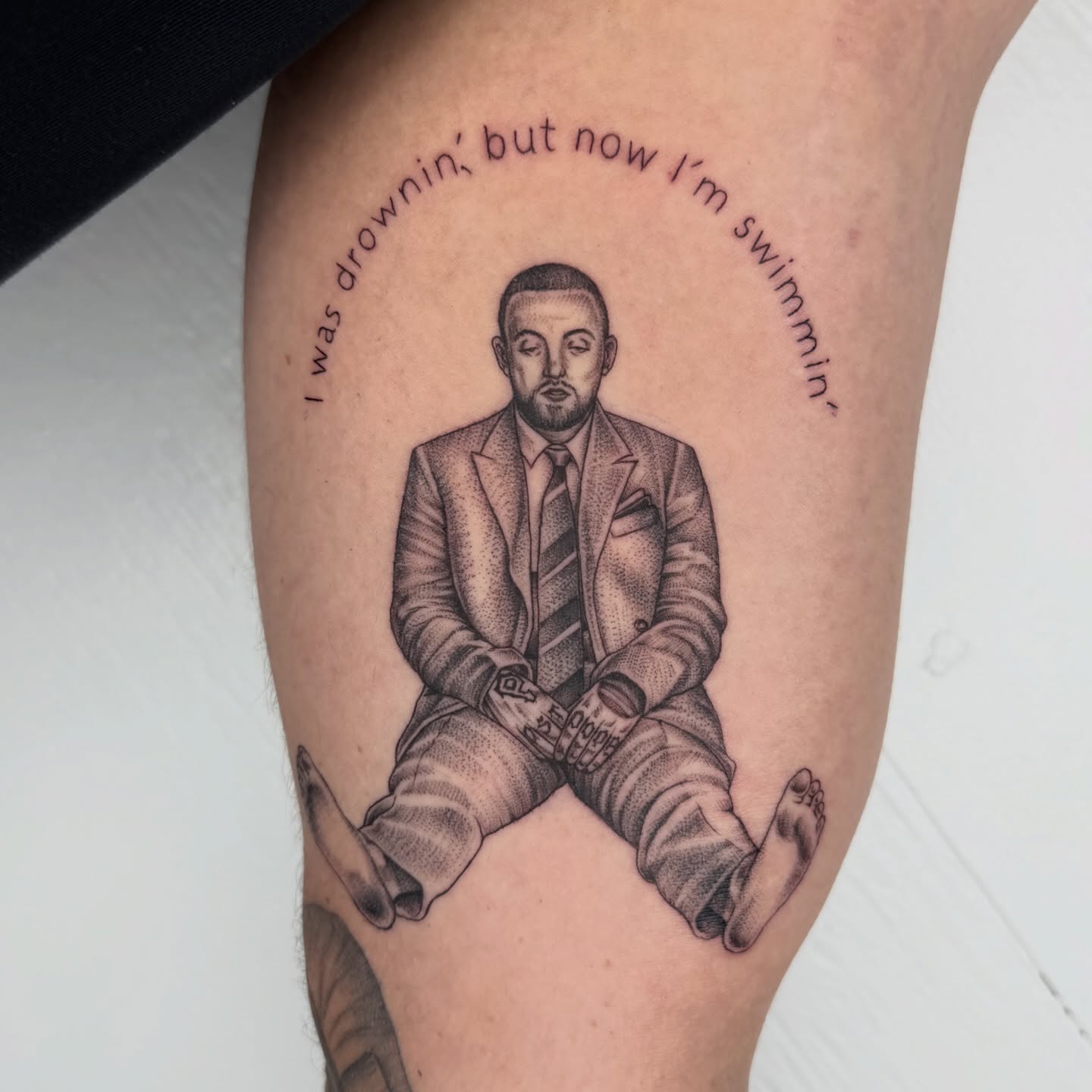 Man in suit black and grey tattoo on the thigh by Rose
