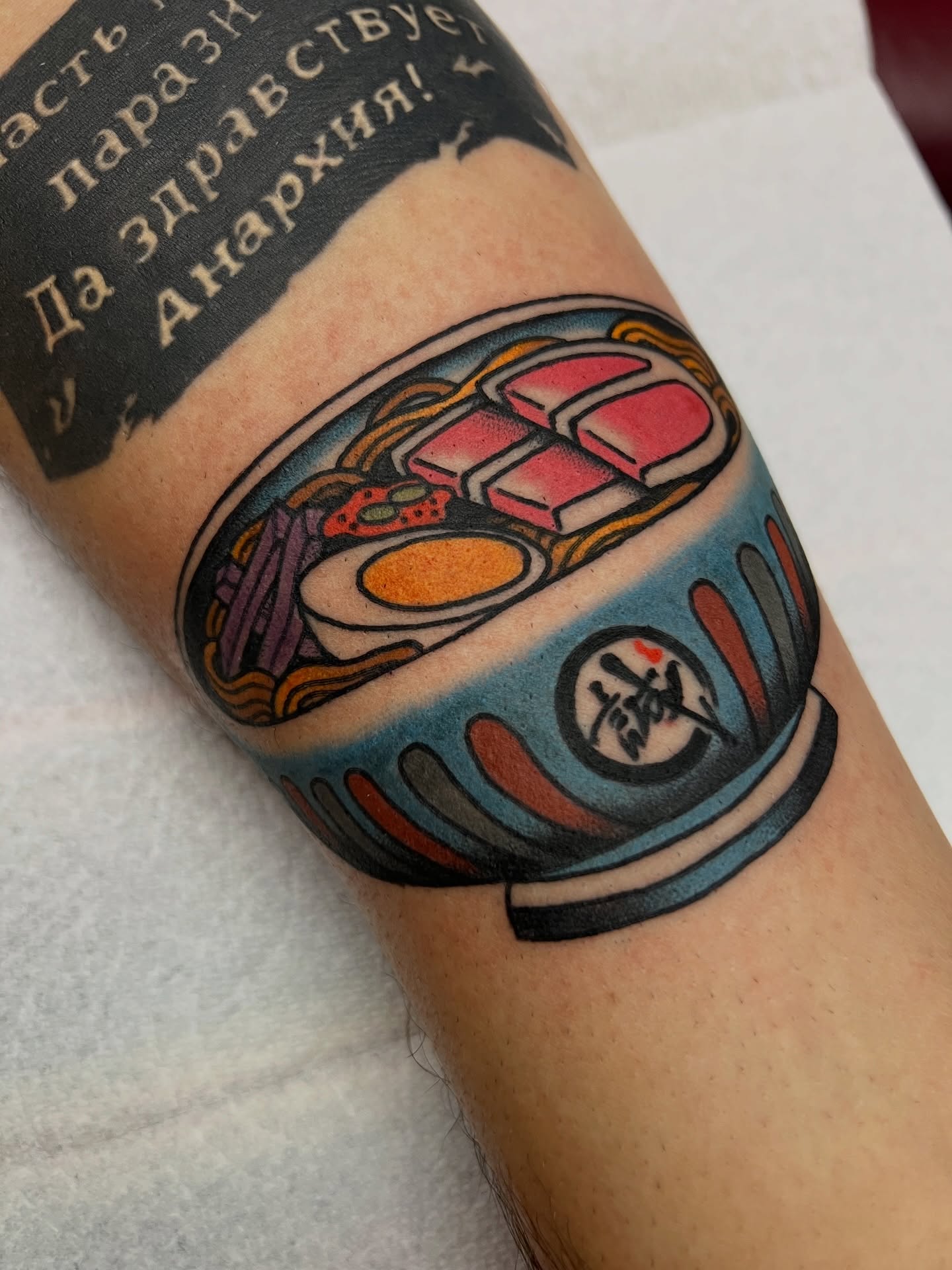 Ramen bowl American traditional tattoo on the forearm by Kelsey Lane