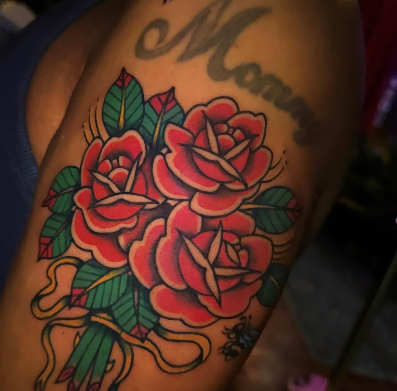 Roses American traditional tattoo on the thigh by Nikki Bee