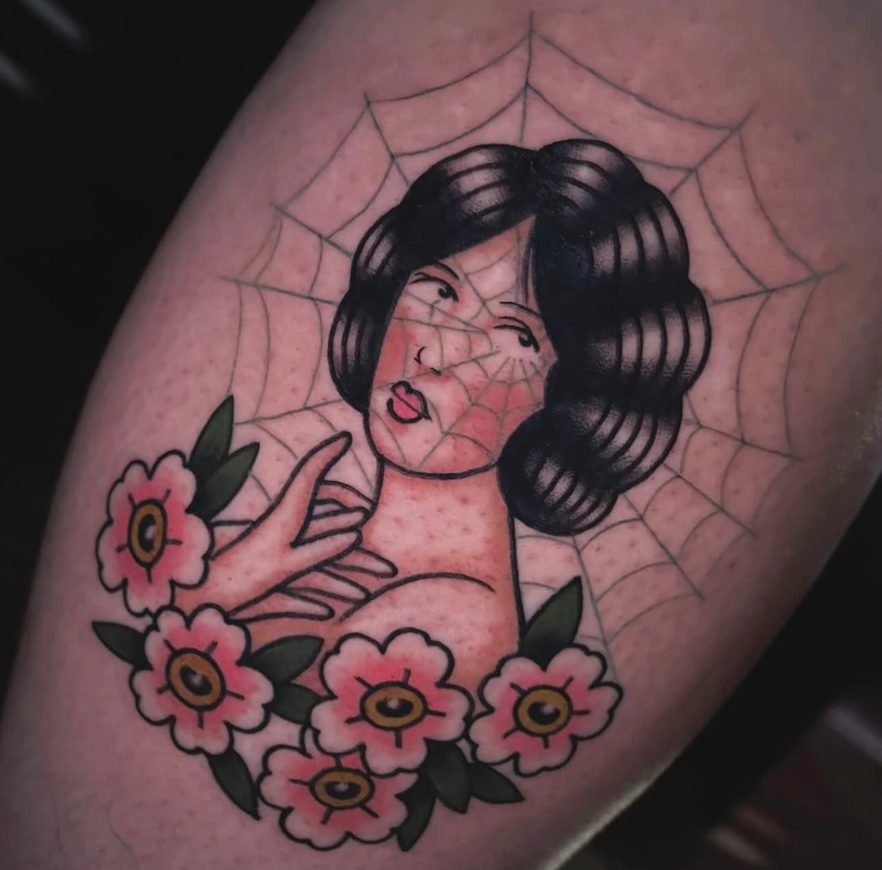 Woman with flowers American traditional tattoo on the forearm by Nikki Bee