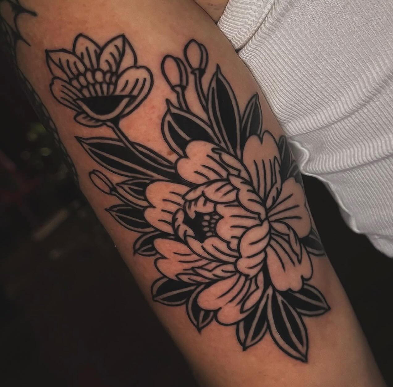 Floral arrangement American traditional tattoo on the forearm by Nikki Bee