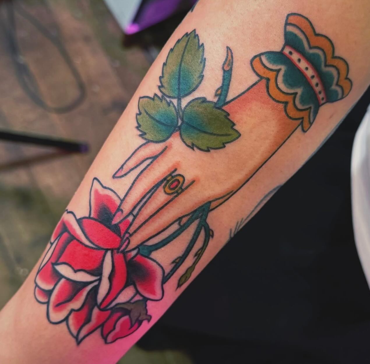 Rose and candle American traditional tattoo on the forearm by Nikki Bee