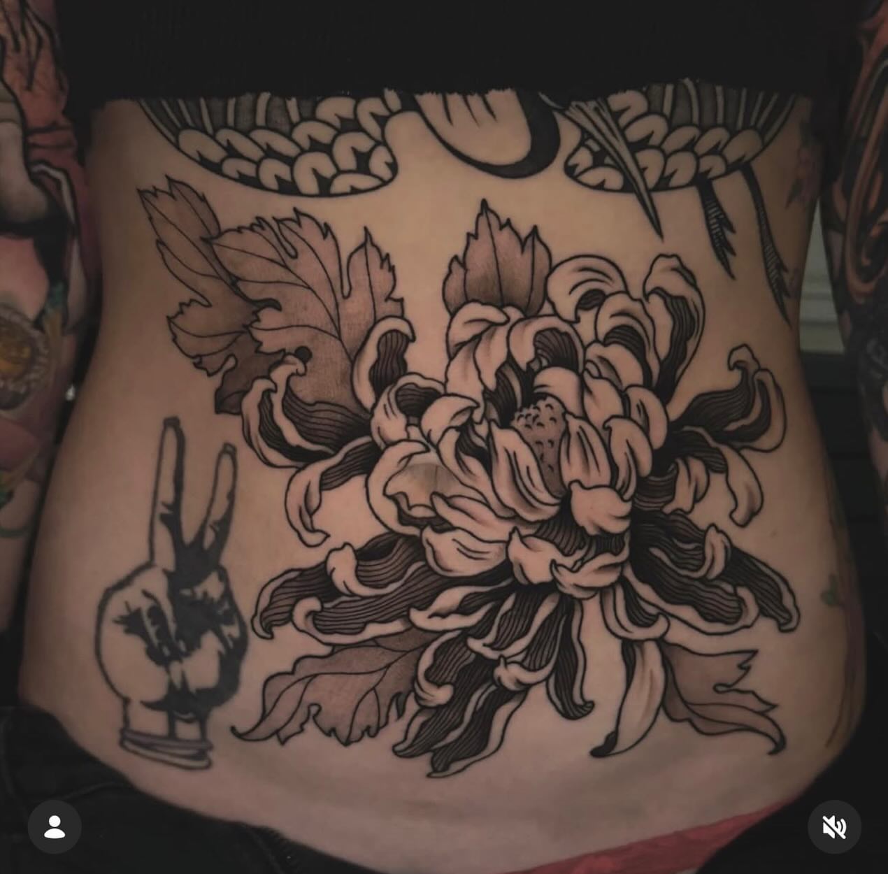 Chrysanthemum black and grey tattoo on the torso by Nikki Bee
