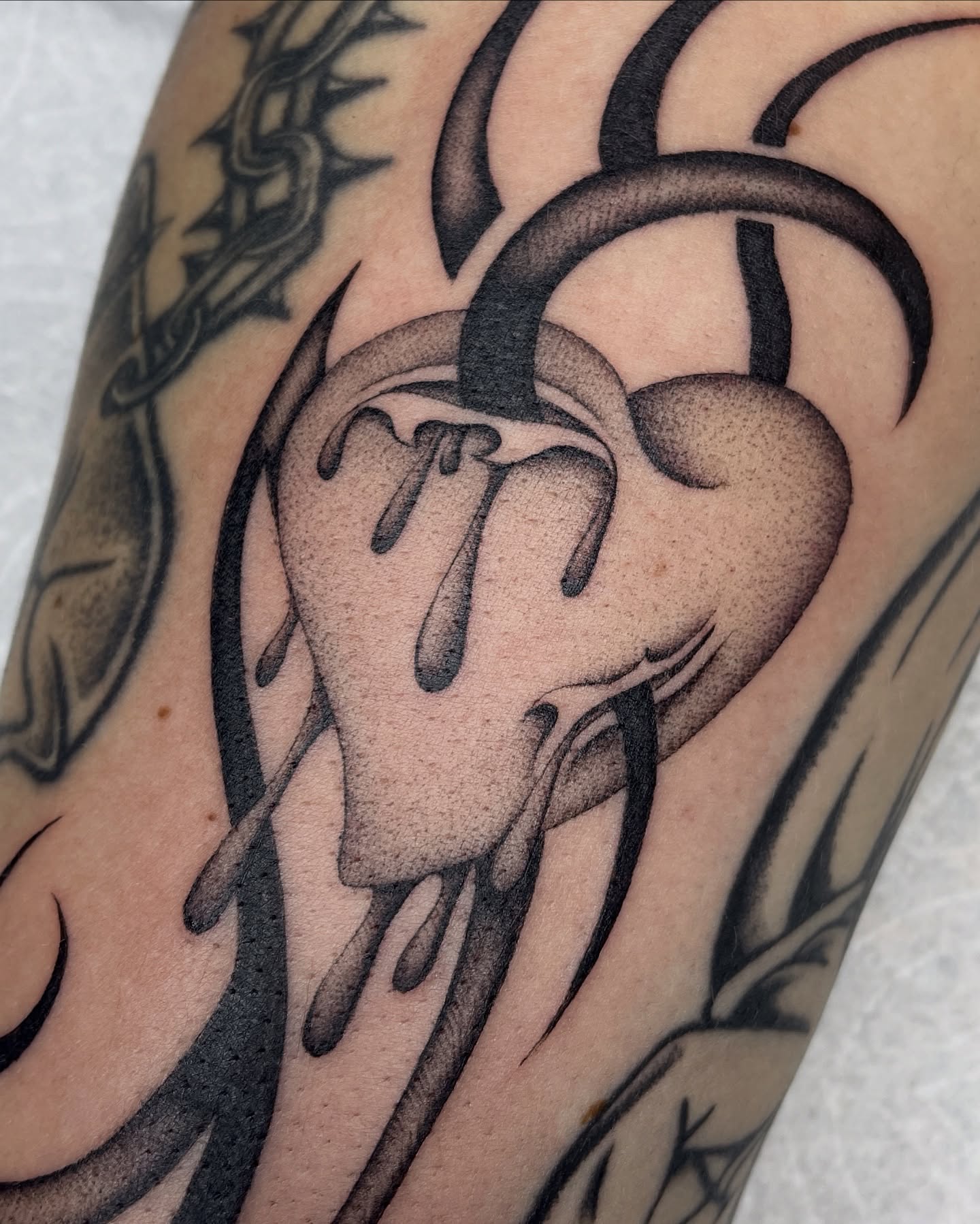 Melting heart black and grey tattoo on the forearm by IVY