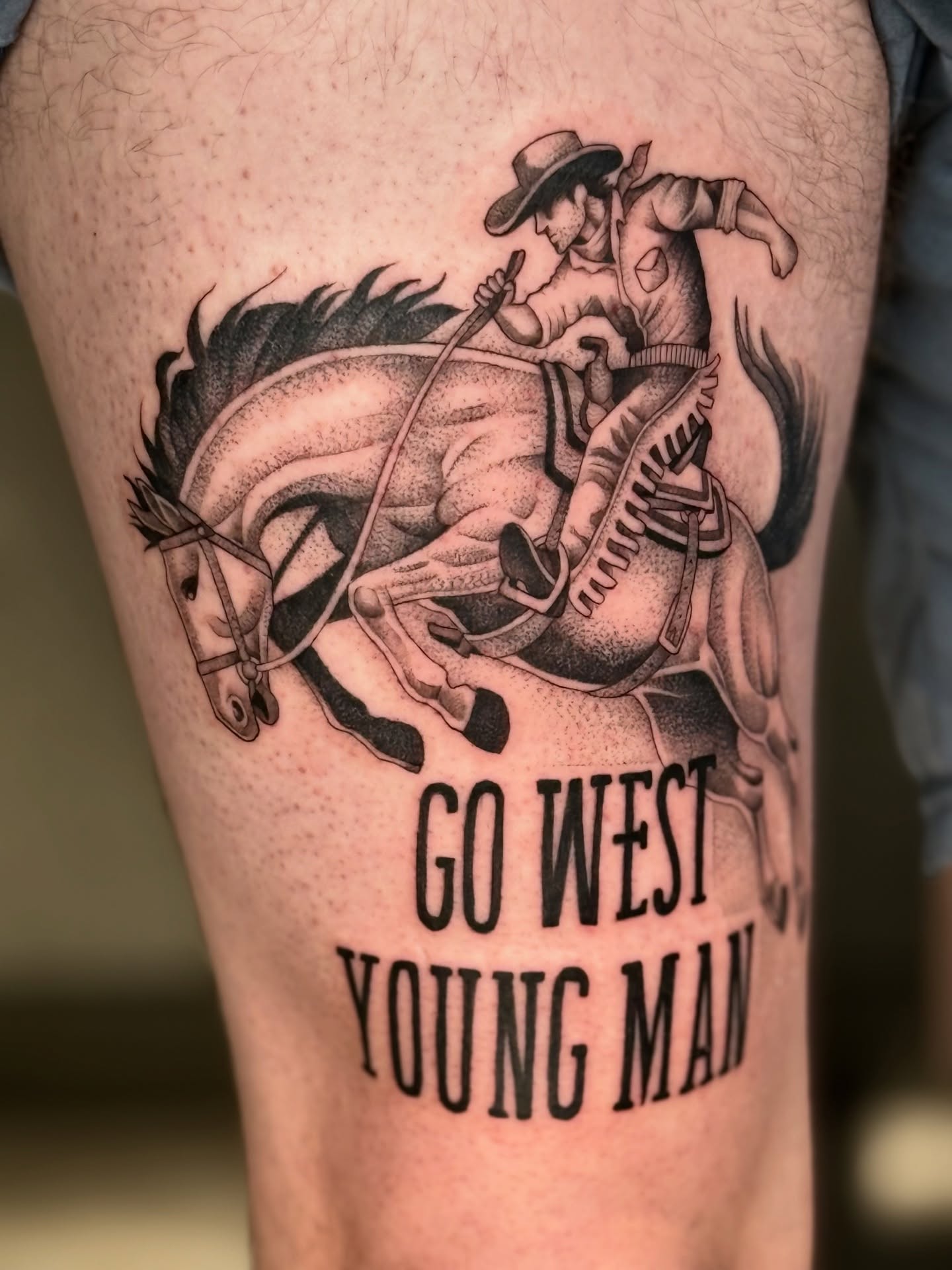 Cowboy riding horse realism tattoo on the thigh by Miles Romero Smith