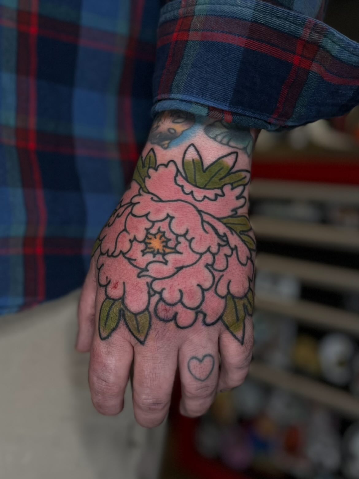 Peony American traditional tattoo on the hand by Kaichi Fujita, Eugene, Oregon