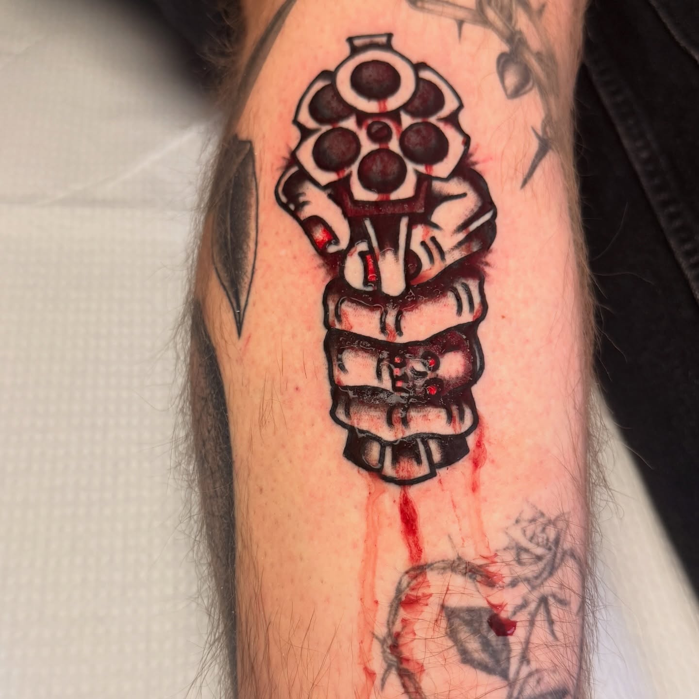 Gun and skull neo-traditional tattoo on the forearm by Stevie Lowenstein, Cincinnati, Ohio