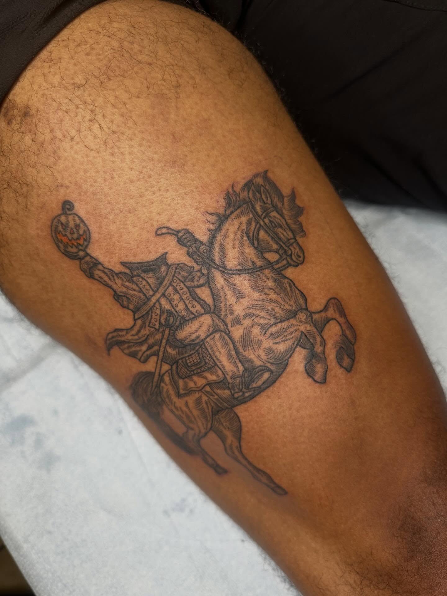 Horse and rider black and grey tattoo on the thigh by Alex Gunshefski