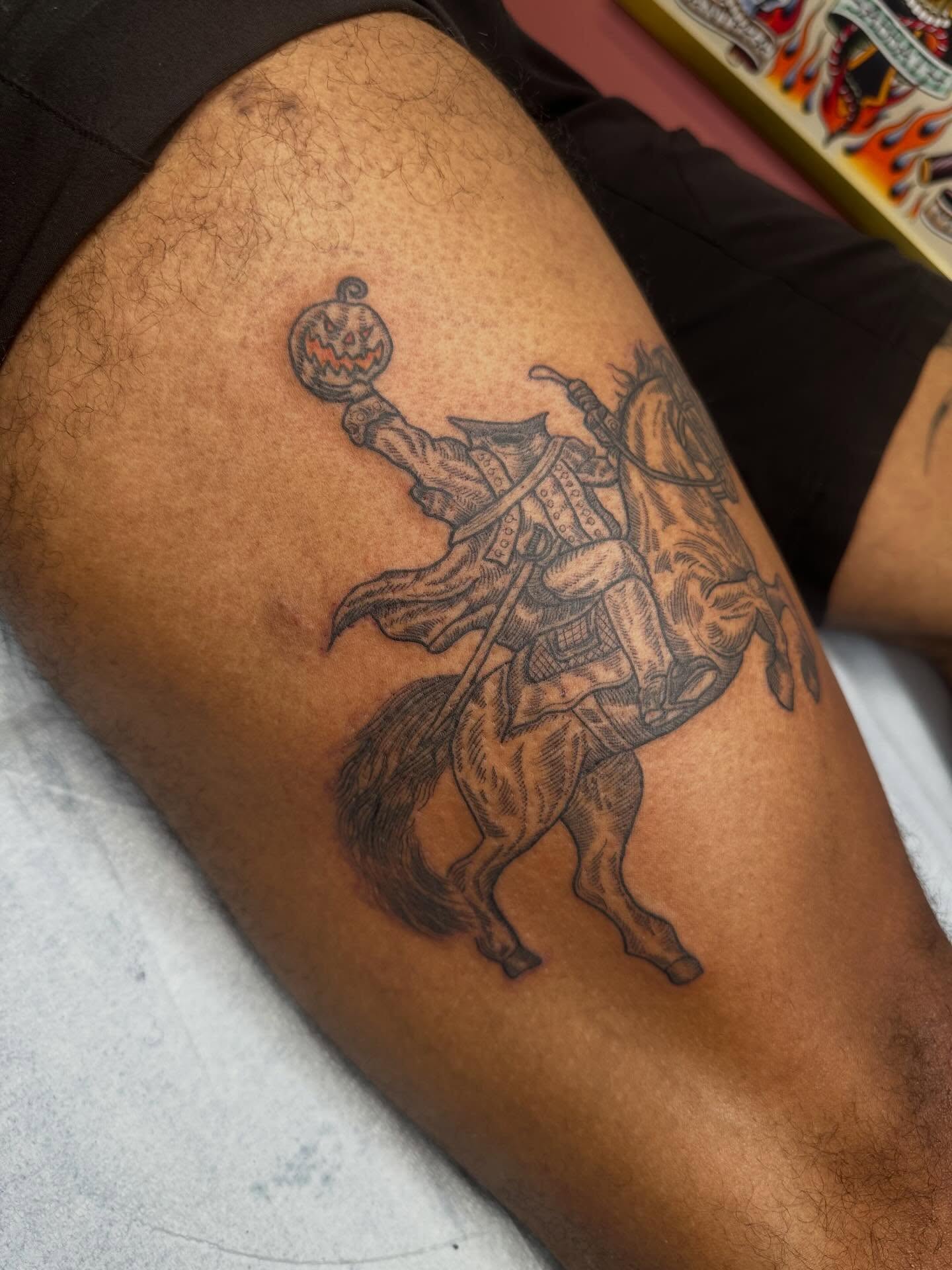Horseman with pumpkin black and grey tattoo on the thigh by Alex Gunshefski