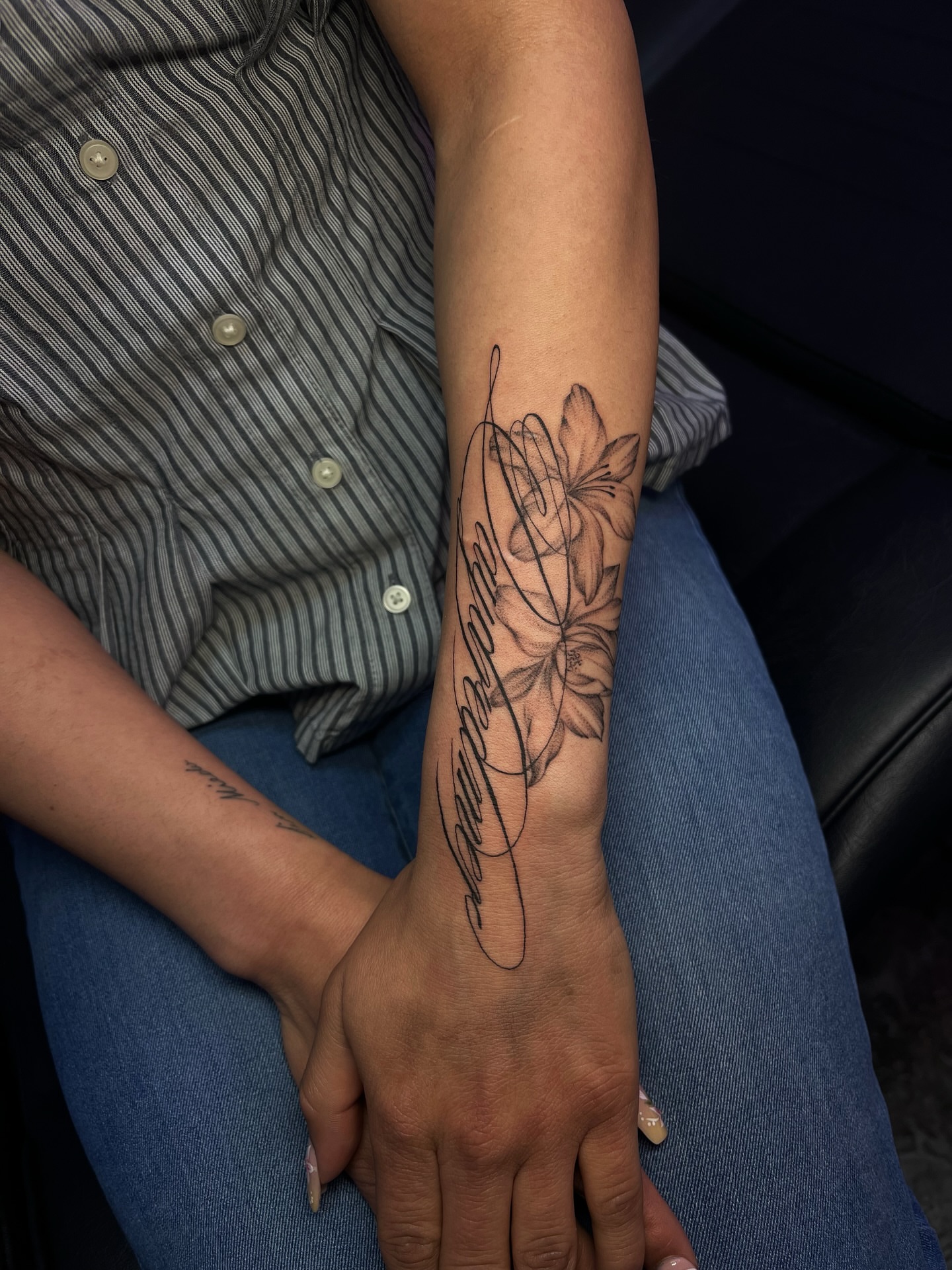 Lotus flower black and grey tattoo on the forearm by MK