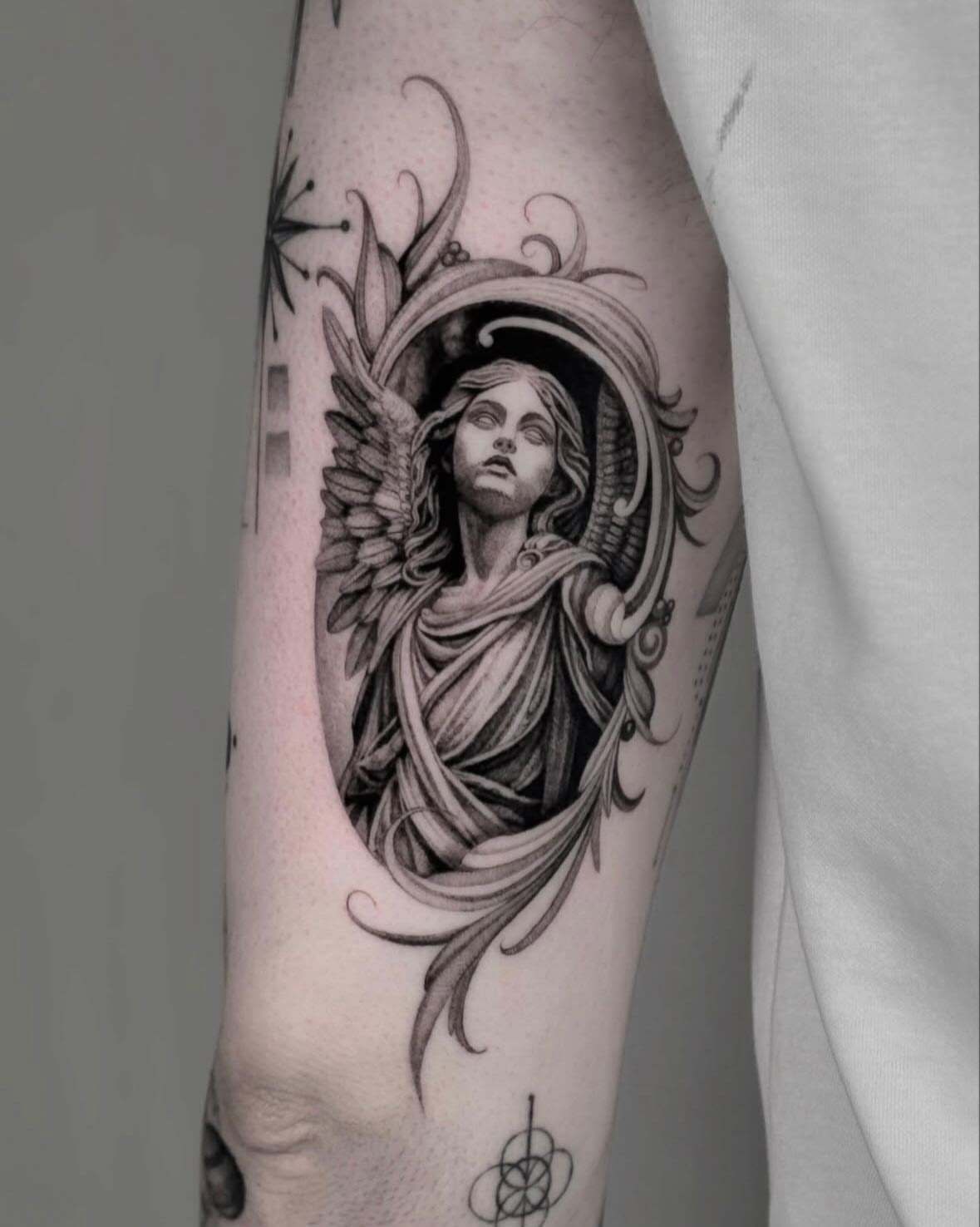 Angel statue realism tattoo on the forearm by Brittney Naami, San Francisco, California