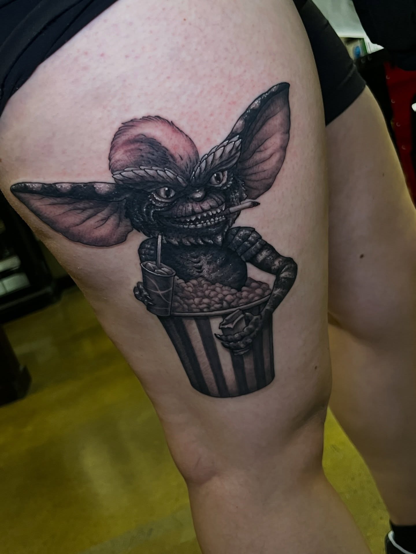 Gremlin realism tattoo on the thigh by Evan Perrine