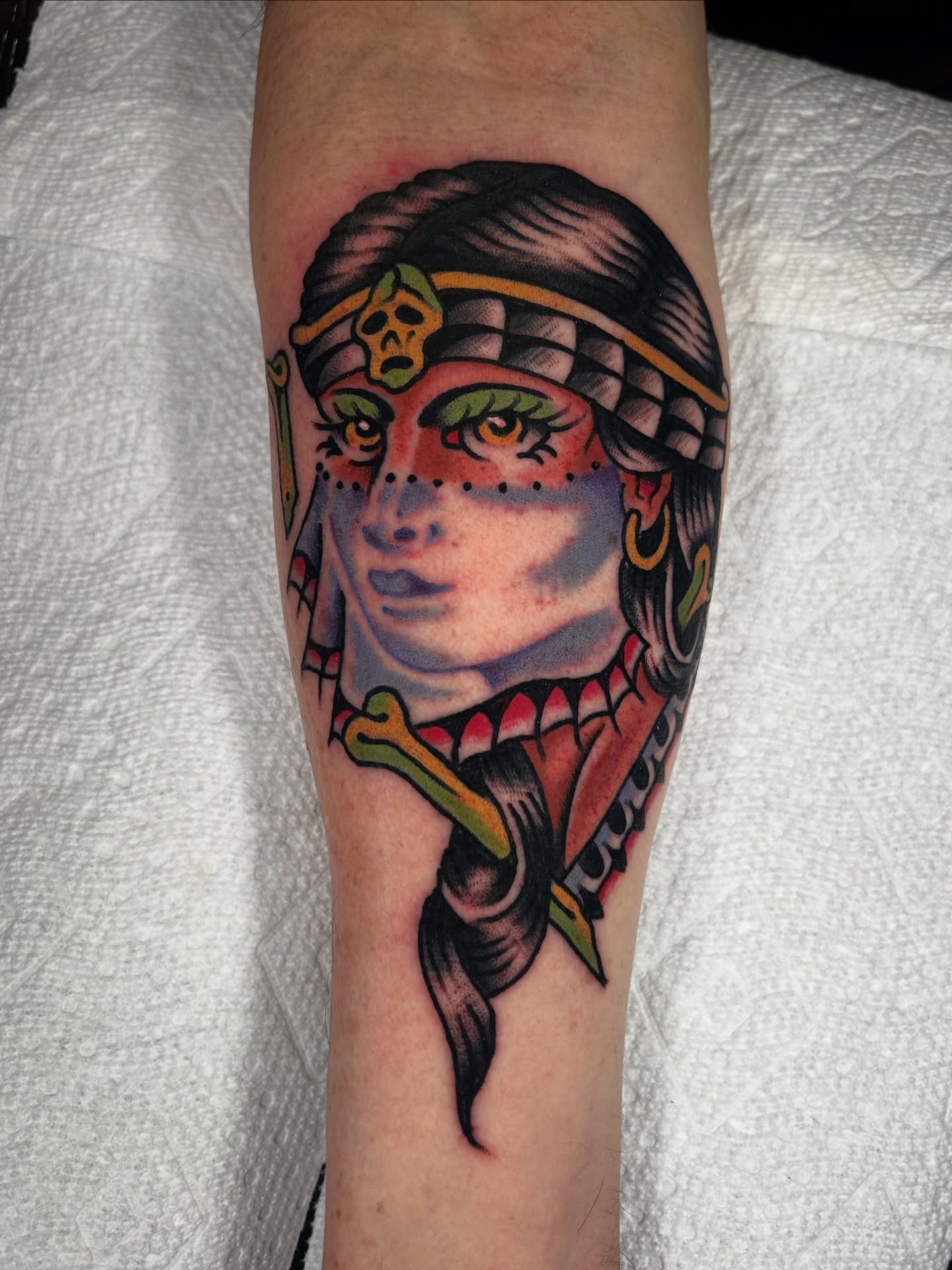 Woman with dragon American traditional tattoo on the forearm by Kit Miller, Indianapolis, Indiana