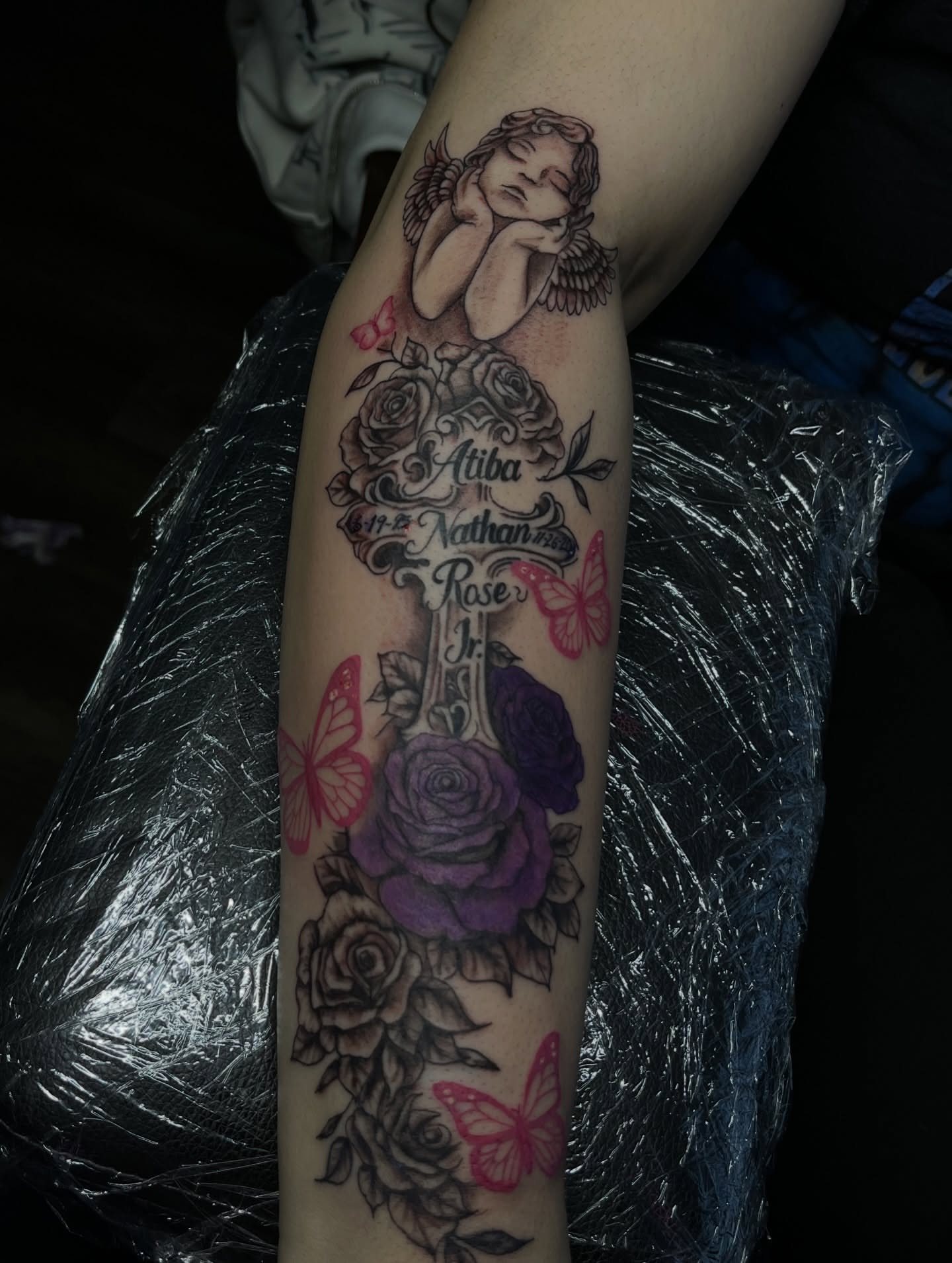 Cross with names American traditional tattoo on the forearm by Tam💟👩🏽‍🎨