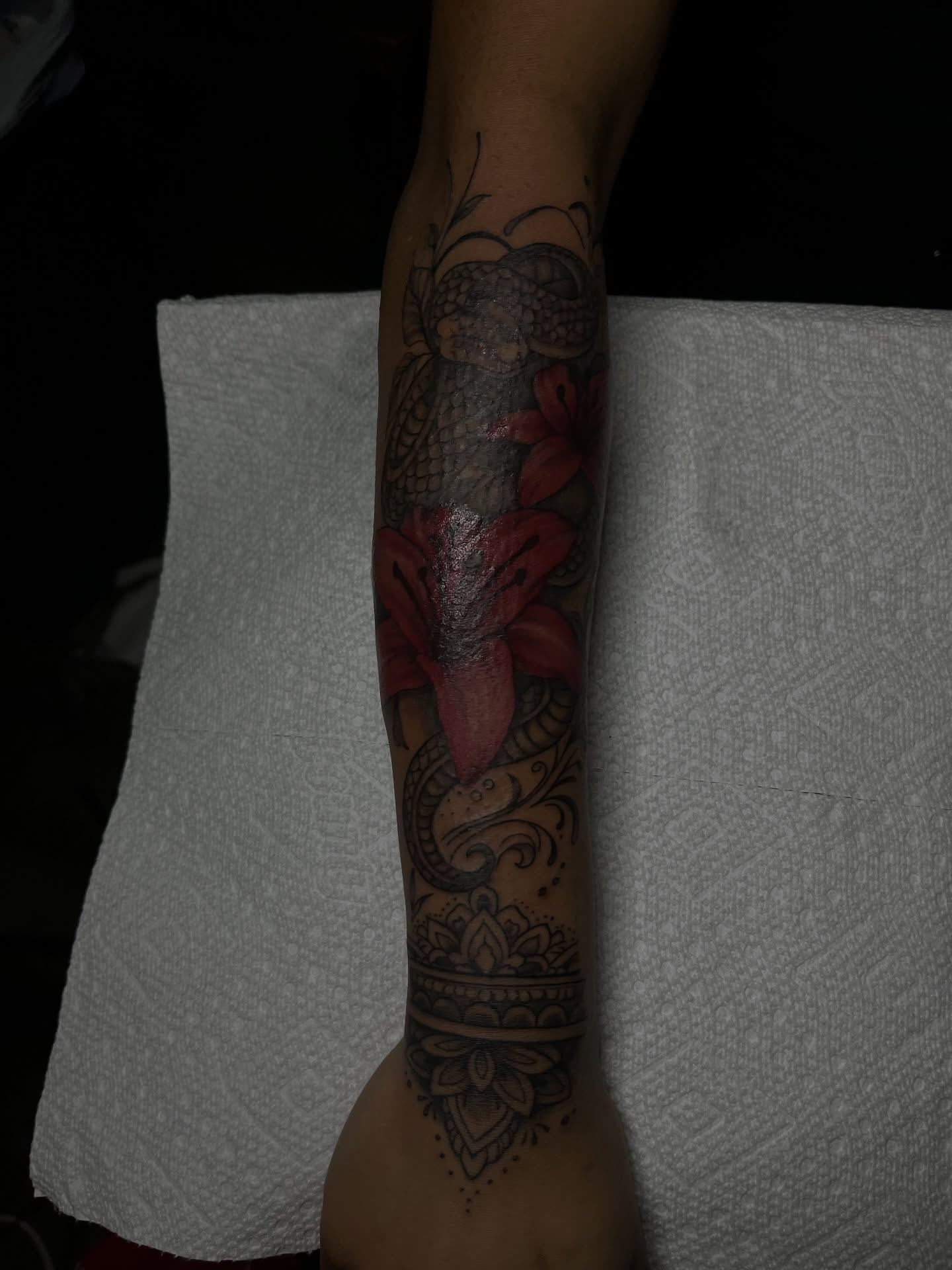 Lily and snake neo-traditional tattoo on the forearm by Tam💟👩🏽‍🎨
