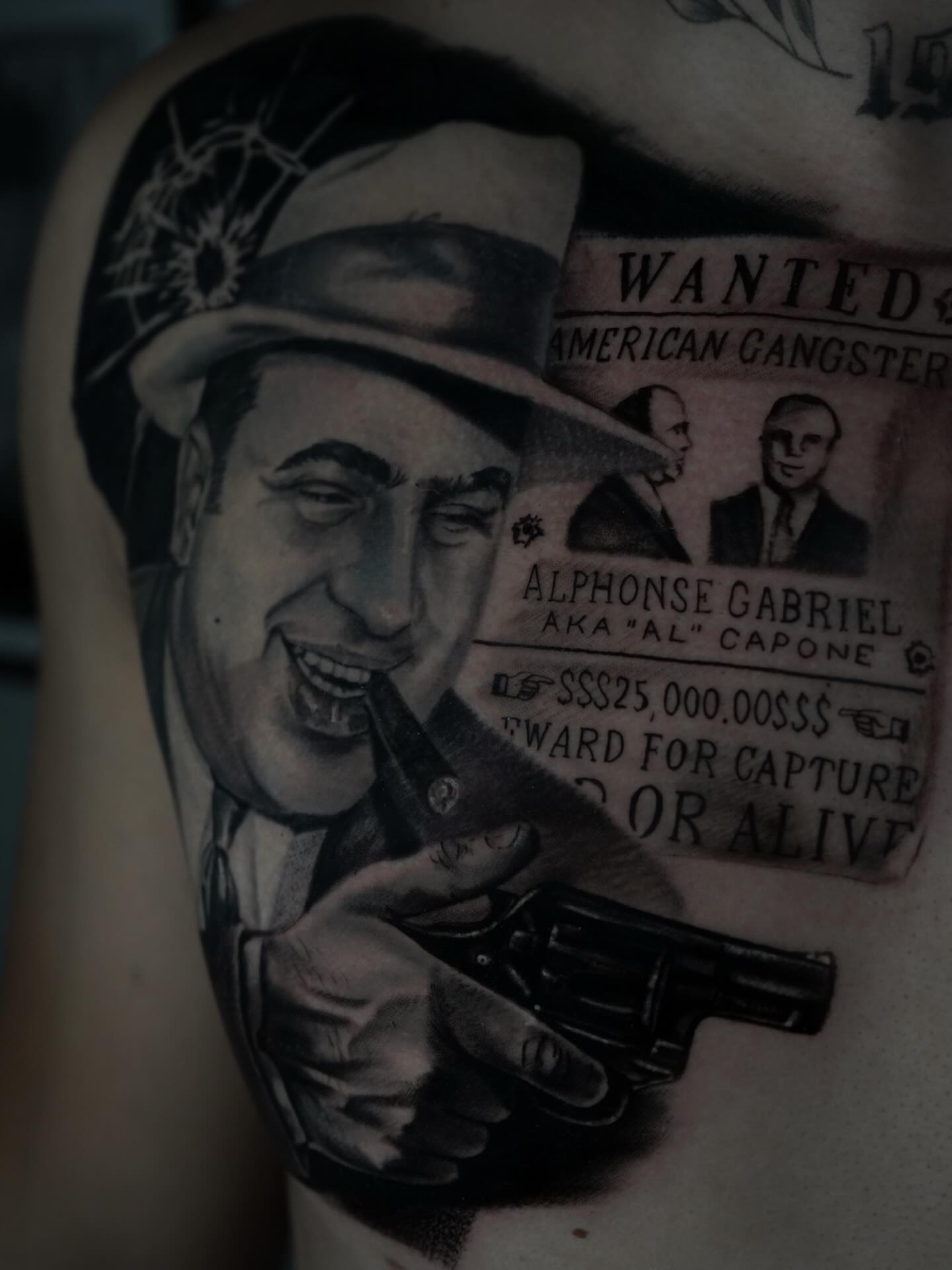 Al Capone realism tattoo on the upper arm by Carlos Trujillo