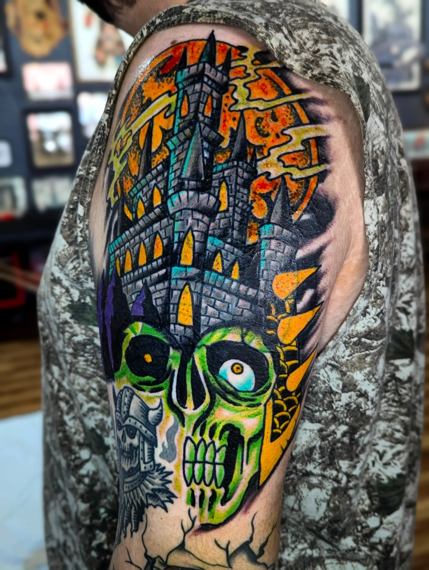 Castle and skull American traditional tattoo on the shoulder by Eric Ward