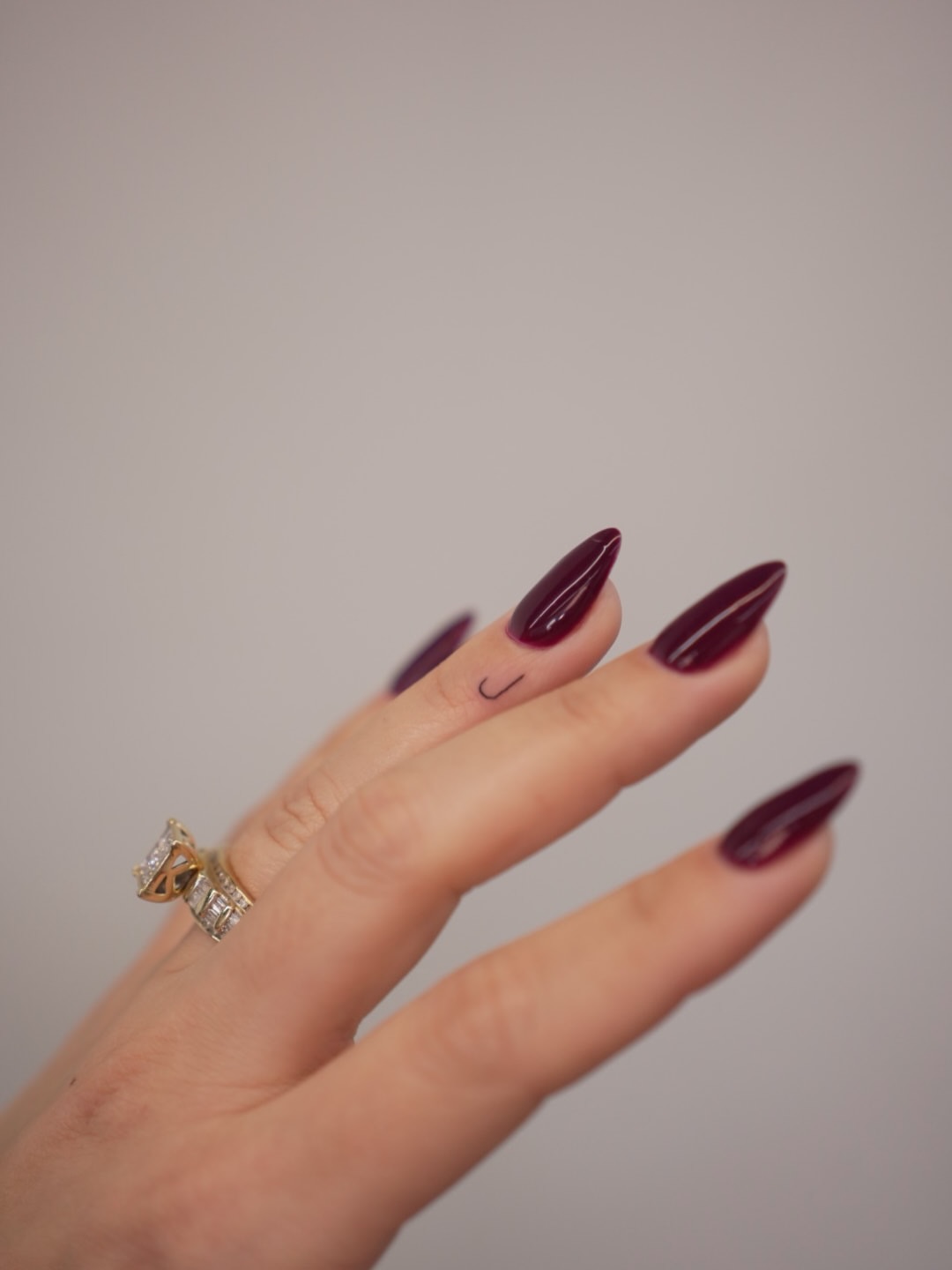 Comma fine line tattoo on the hand by Tattoo fine line NY