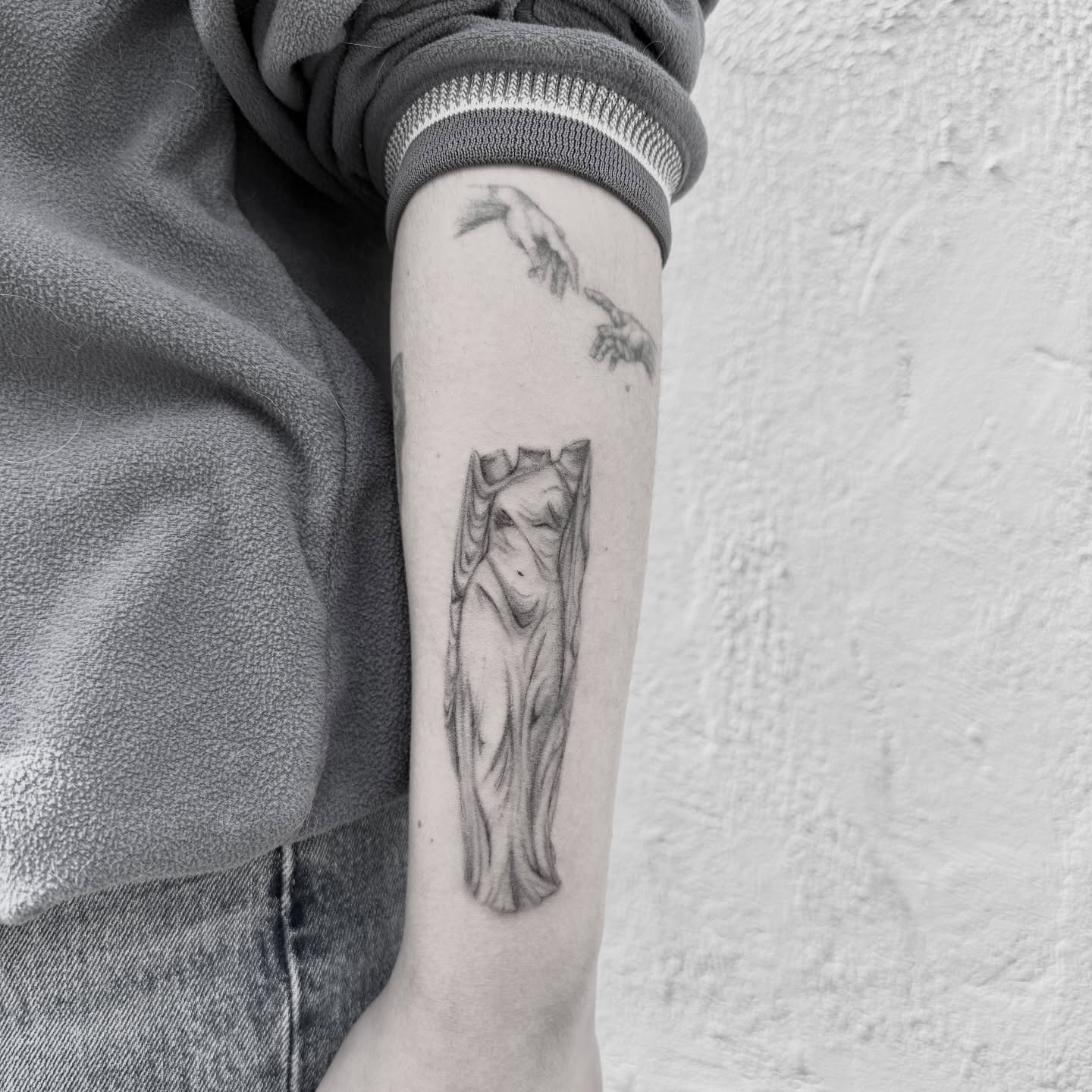 Statue black and grey tattoo on the forearm by Raleigh tattoo artist, Raleigh, North Carolina