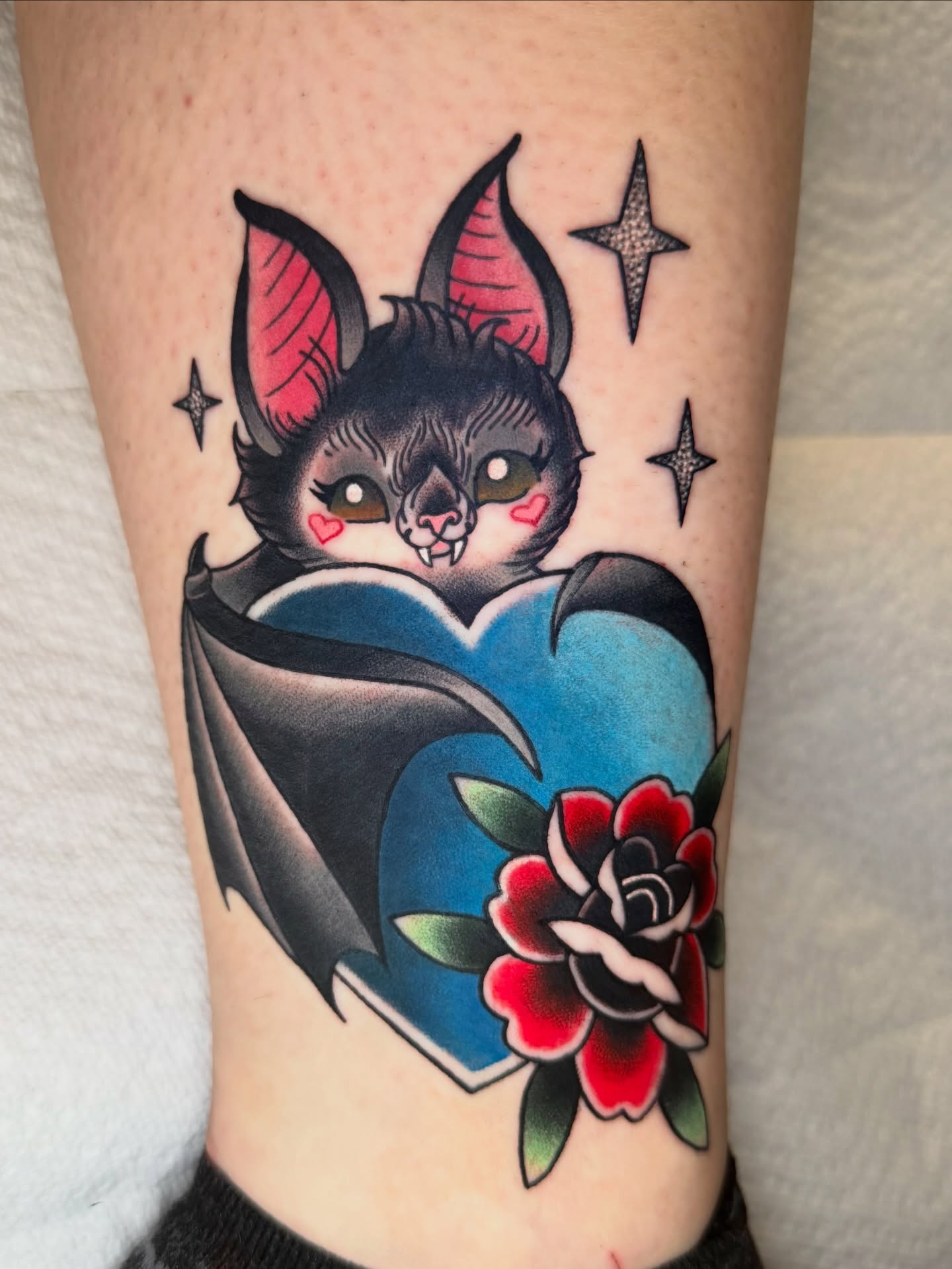 Bat with heart American traditional tattoo on the forearm by Savannah Compton