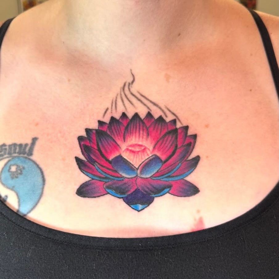 Lotus flower neo-traditional tattoo on the chest by spikecitytattoo