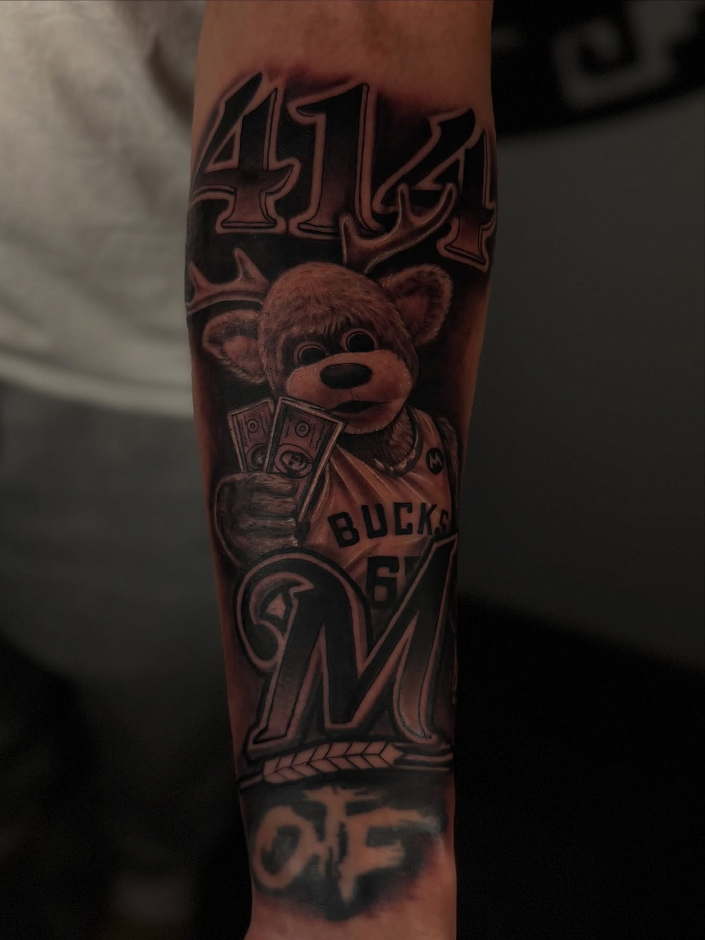 Mascot holding money American traditional tattoo on the forearm by Dreamchaserink