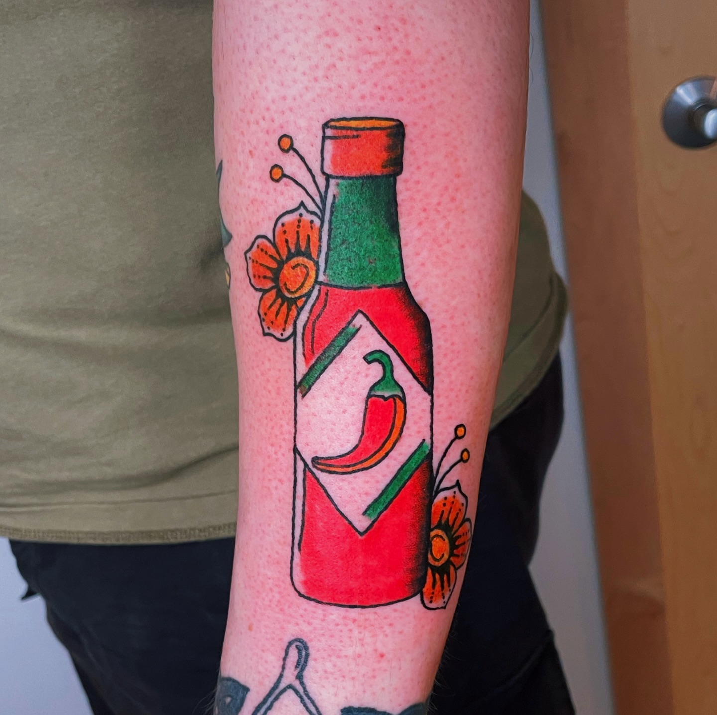 Hot sauce bottle American traditional tattoo on the forearm by Glume Tattoo