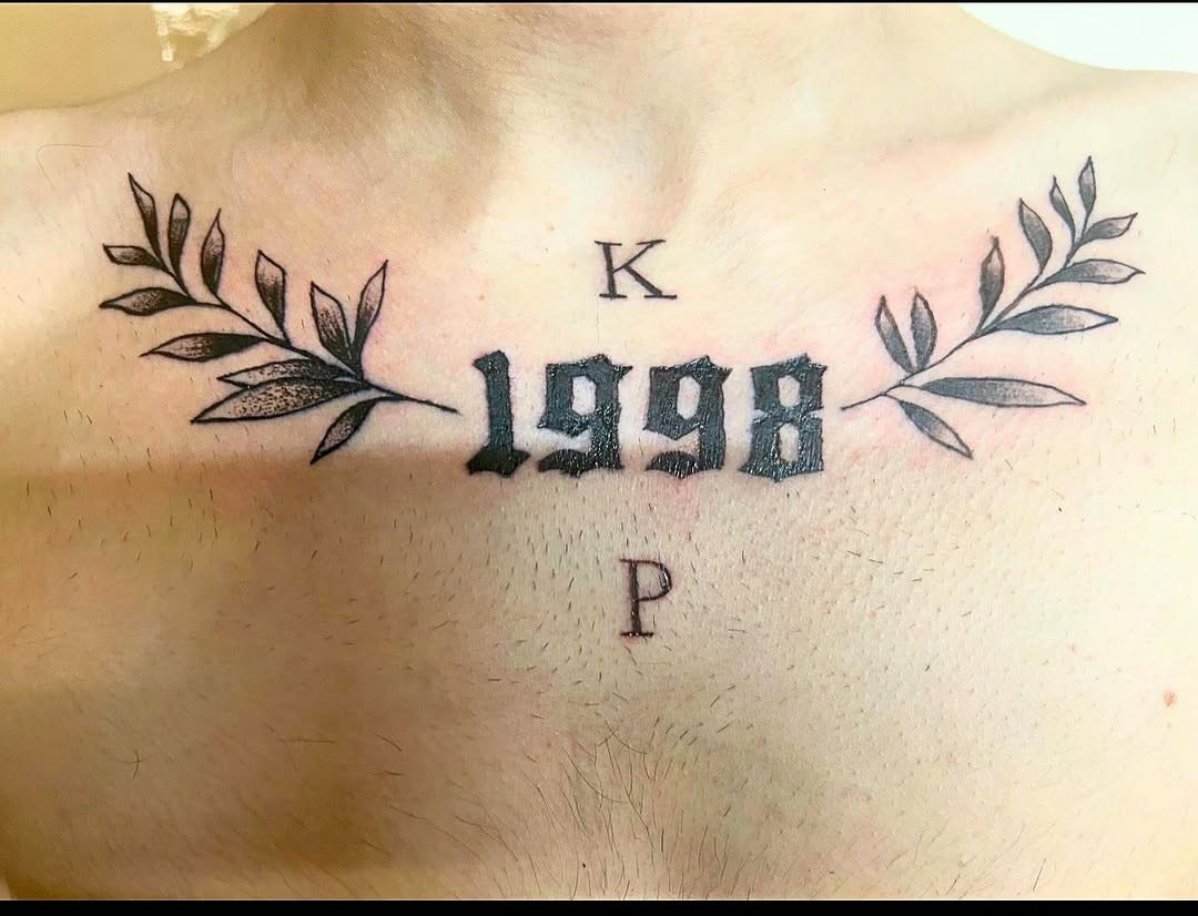 Year 1998 with branches and initials tattoo on the chest by MY$T