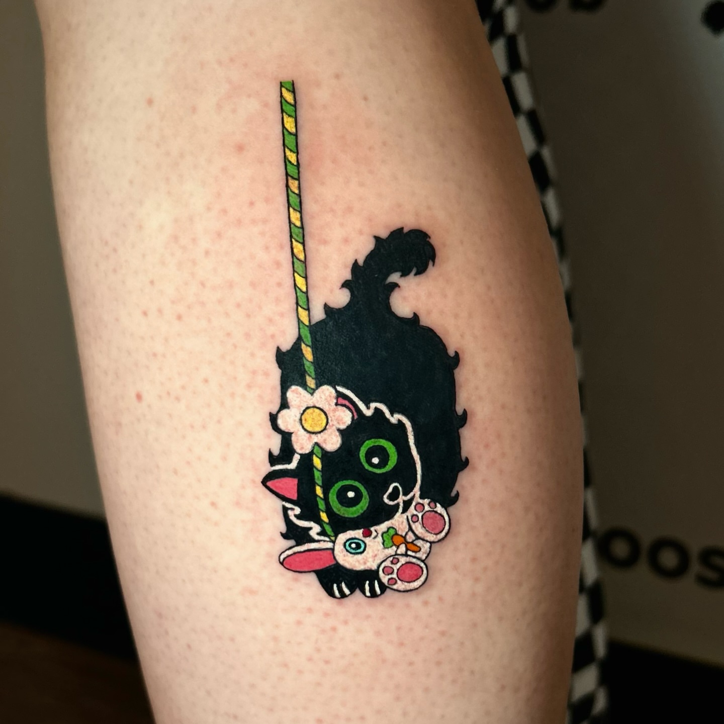 Cat with lollipop new school tattoo on the thigh by Tess